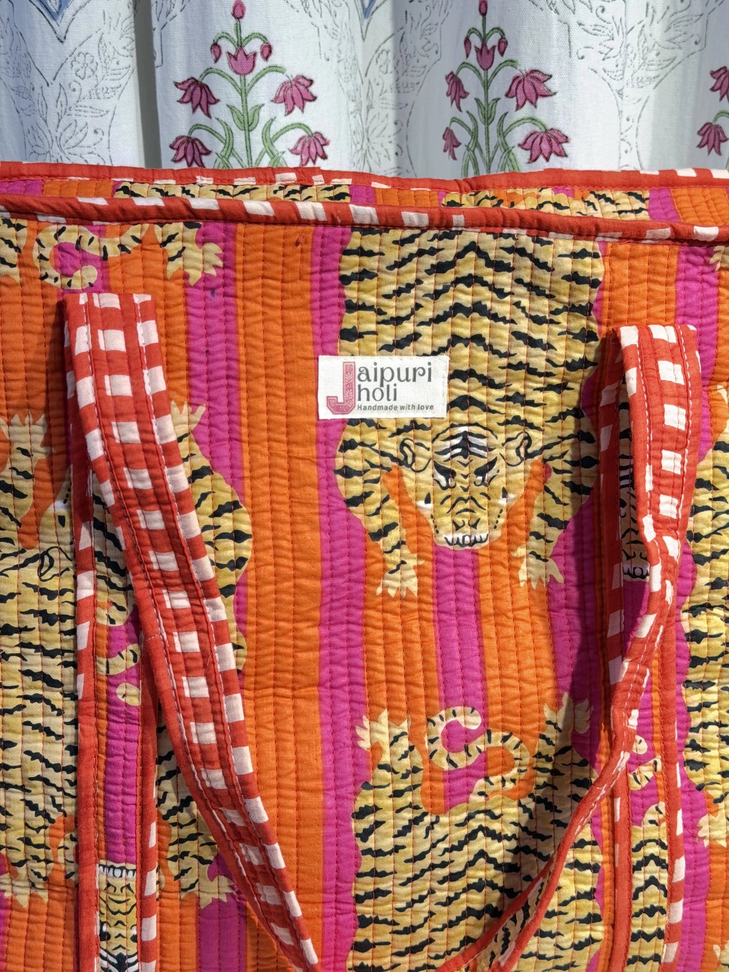 Jaipur block print cotton quilted large tote bag with matching flat pouch, orange and pink tiger animal print, 18×18×6 inch tote with 9×7 inch flat pouch for stationery, chargers and travel essentials close-up view