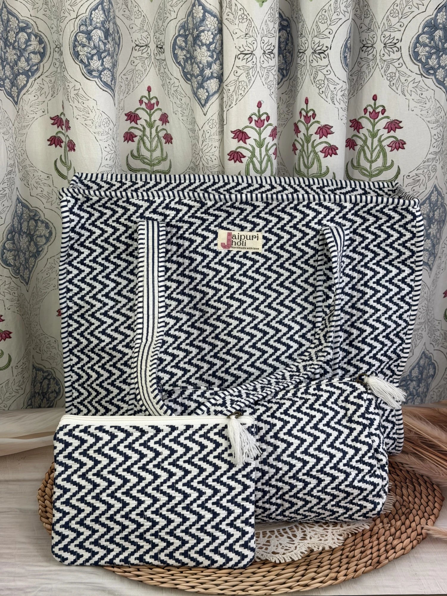 Jaipur block print cotton quilted large zip tote bag with matching toiletry pouch and flat pouch, blue and white geometric zigzag print, 18 × 18 × 6 inch tote, 10 × 6 inch toiletry pouch and 9 × 7 inch flat pouch front view