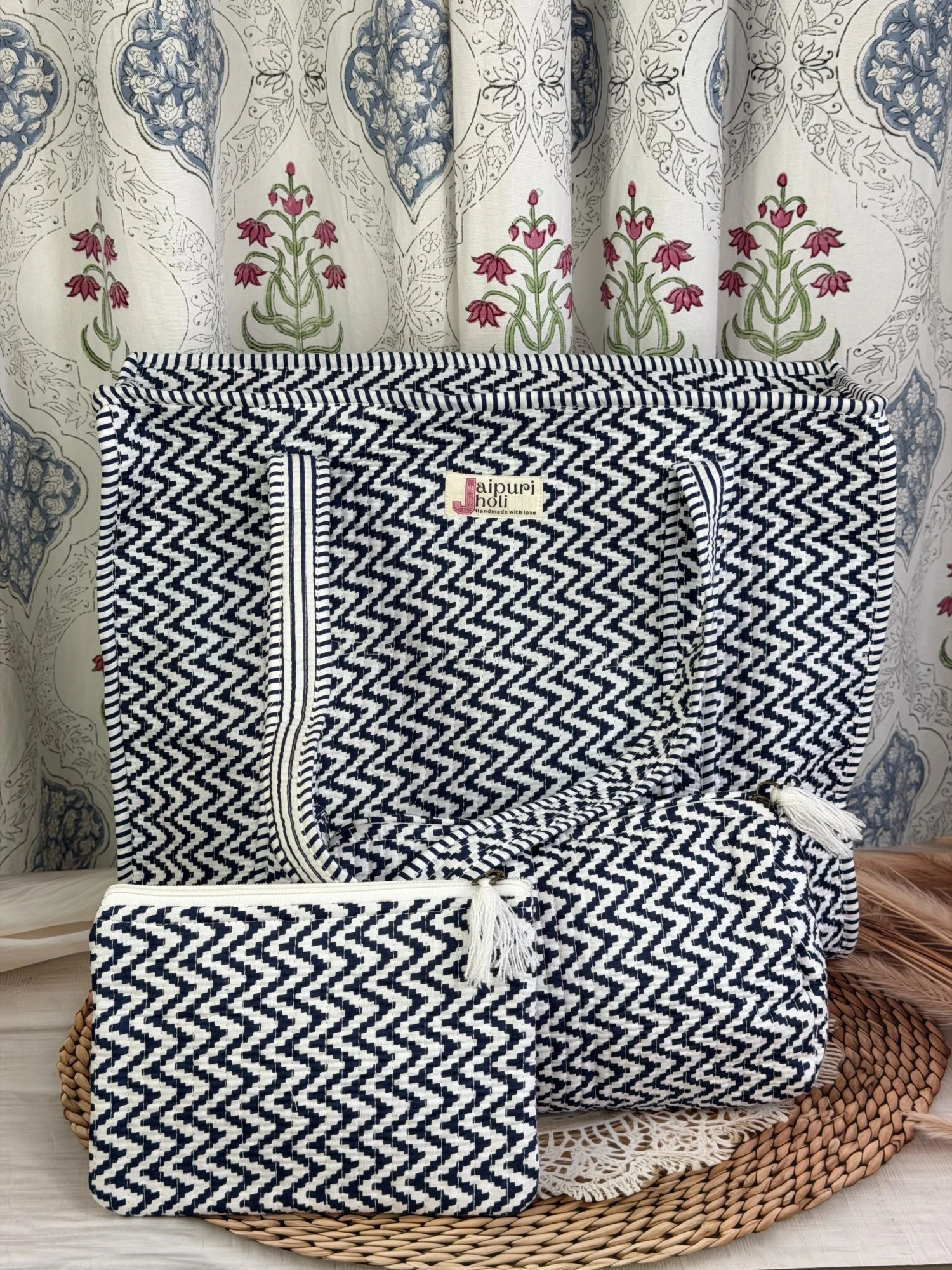Jaipur block print cotton quilted large zip tote bag with matching toiletry pouch and flat pouch, blue and white geometric zigzag print, 18 × 18 × 6 inch tote, 10 × 6 inch toiletry pouch and 9 × 7 inch flat pouch side view