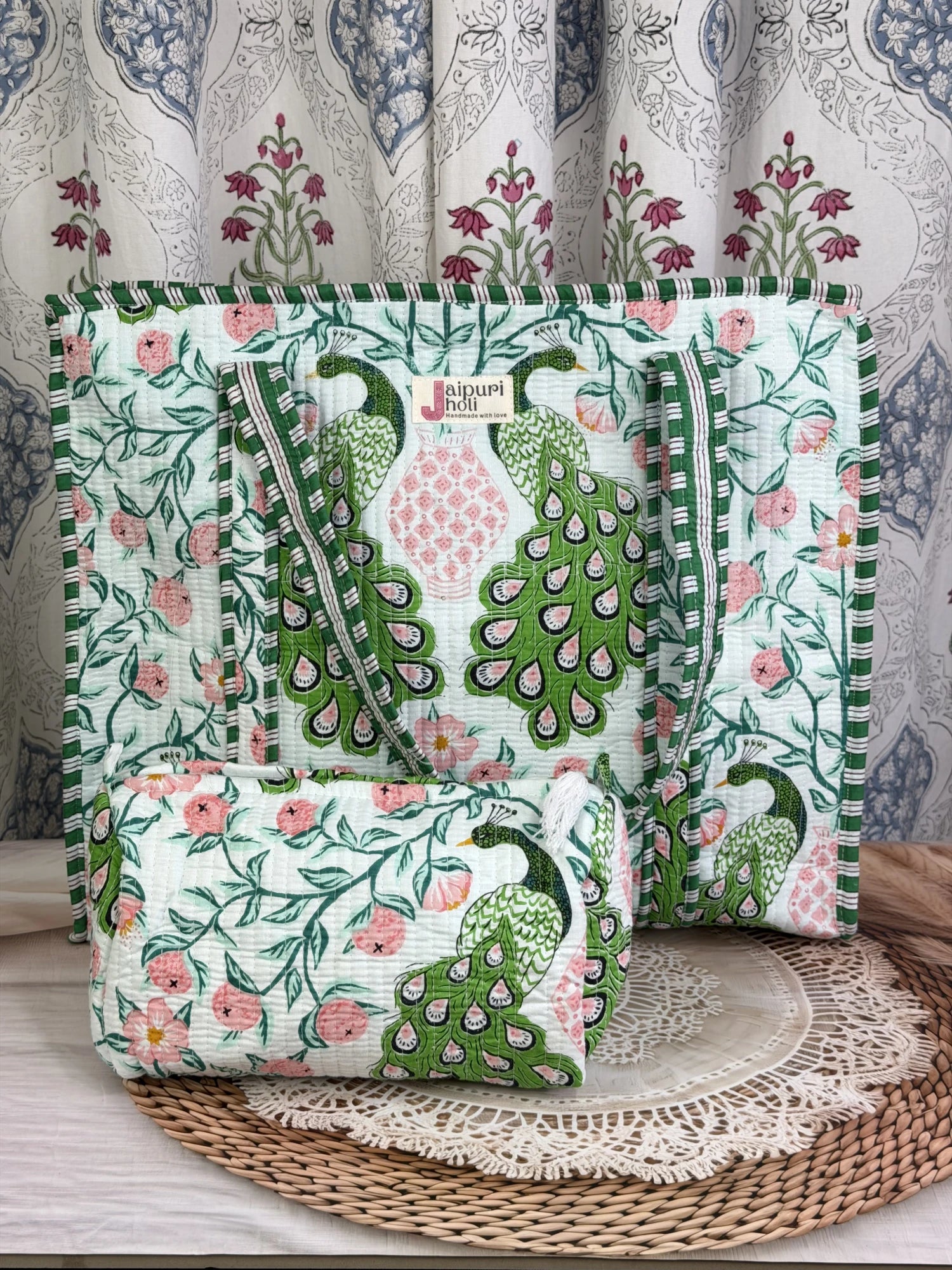 Jaipur block print cotton quilted large zip tote bag with matching toiletry pouch and flat pouch, green and pink peacock print, 18 × 18 × 6 inch tote, 10 × 6 inch toiletry pouch and 9 × 7 inch flat pouch front view
