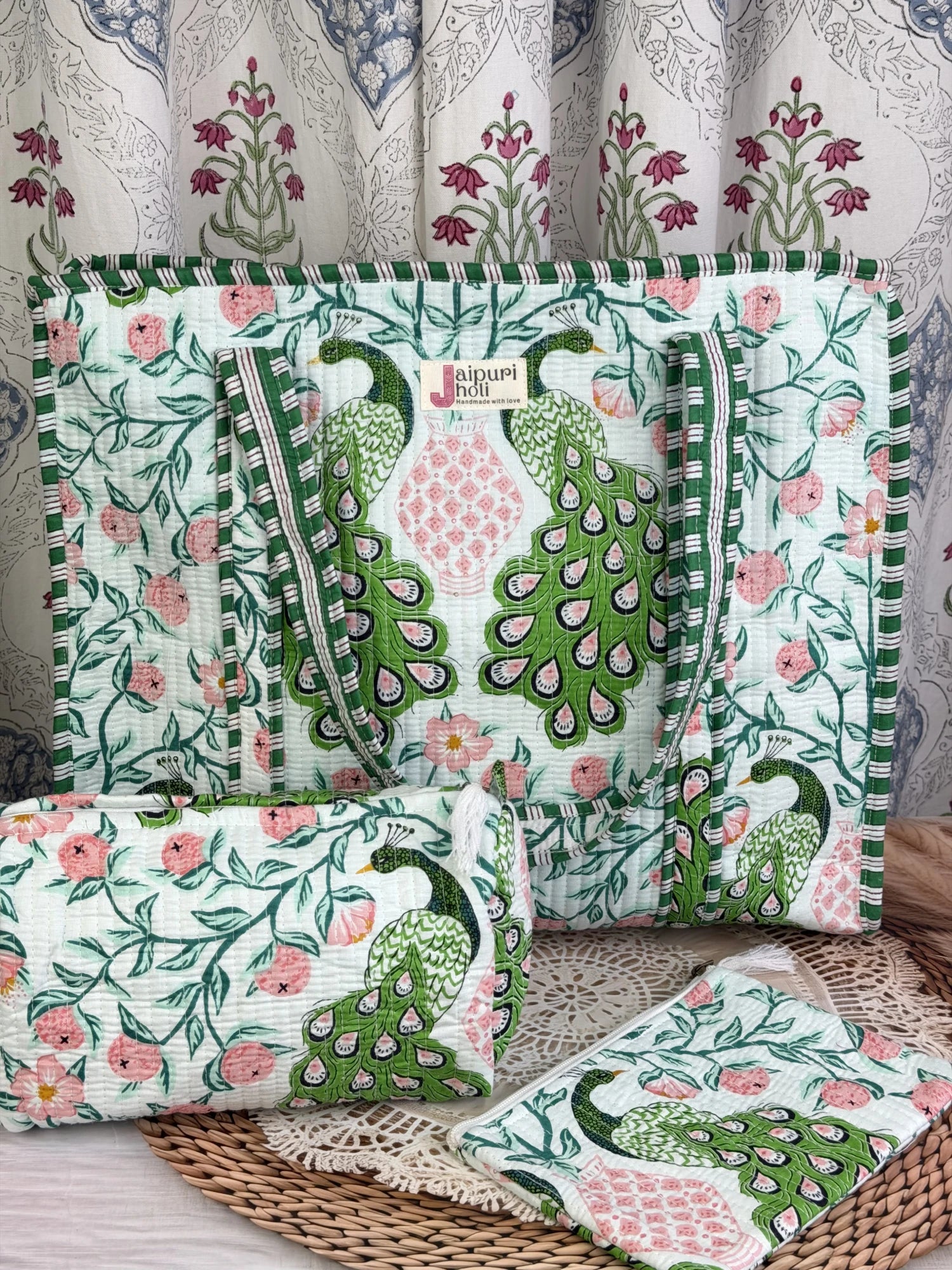 Jaipur block print cotton quilted large zip tote bag with matching toiletry pouch and flat pouch, green and pink peacock print, 18 × 18 × 6 inch tote, 10 × 6 inch toiletry pouch and 9 × 7 inch flat pouch close-up view