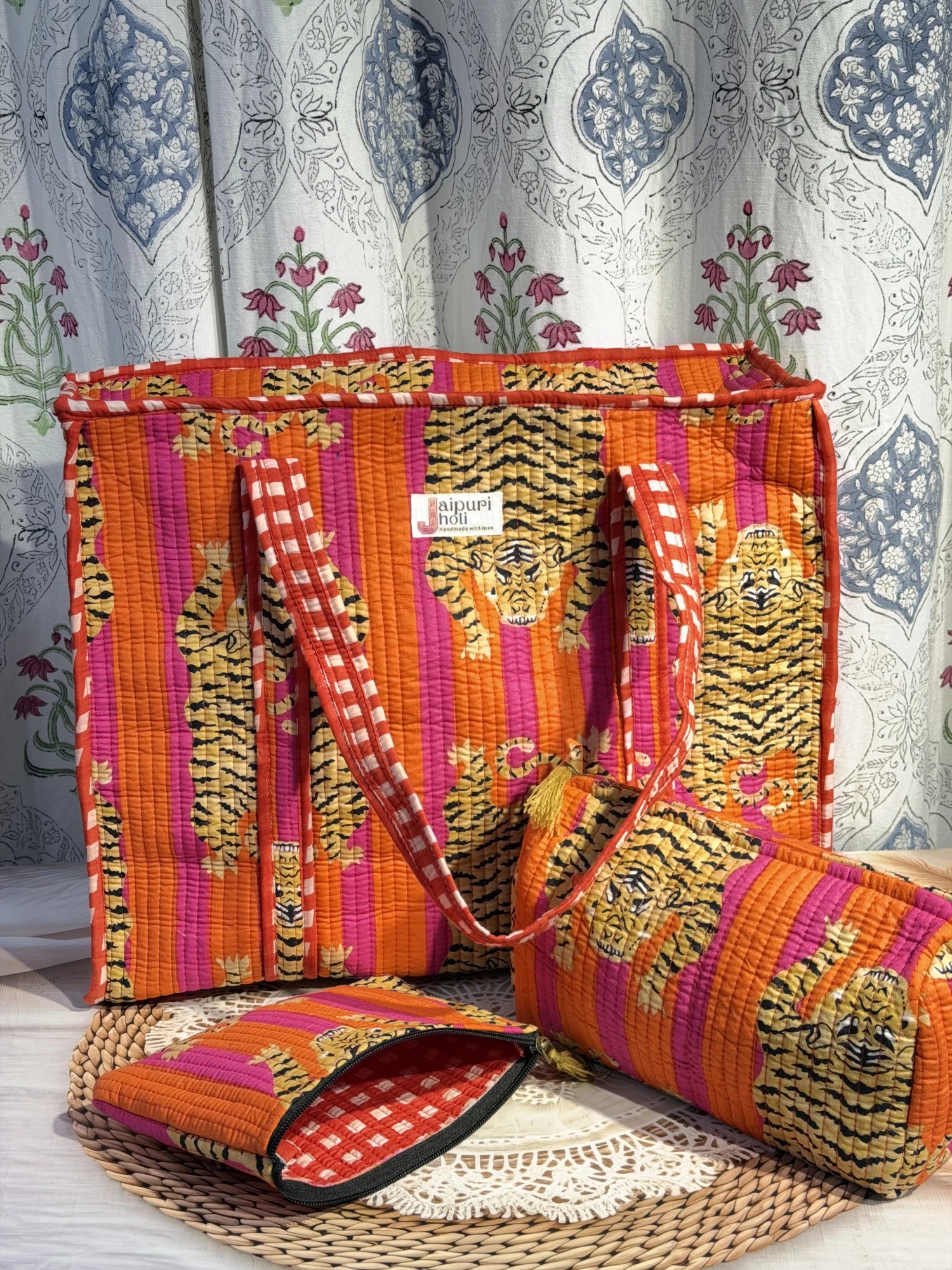 Jaipur block print cotton quilted large zip tote bag with matching toiletry pouch and flat pouch, orange and pink tiger animal print, 18 × 18 × 6 inch tote, 10 × 6 inch toiletry pouch and 9 × 7 inch flat pouch close-up view
