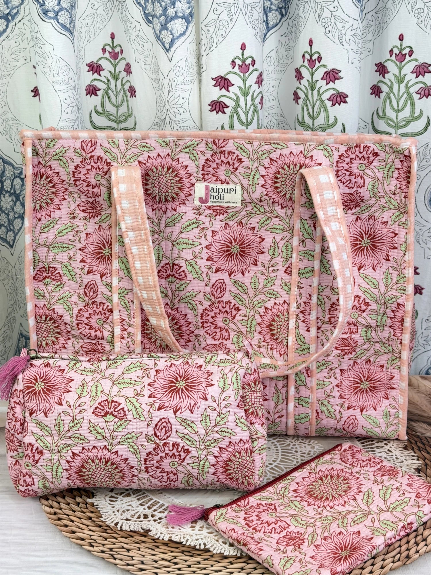 Jaipur block print cotton quilted large zip tote bag with matching toiletry pouch and flat pouch, peach and pink floral print, 18 × 18 × 6 inch tote, 10 × 6 inch toiletry pouch and 9 × 7 inch flat pouch front view