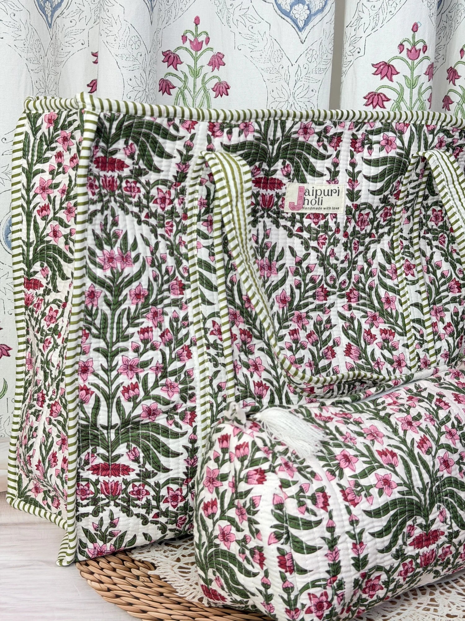 Jaipur block print cotton quilted large zip tote bag with matching toiletry pouch and flat pouch, pink floral and green leaf print, 18 × 18 × 6 inch tote, 10 × 6 inch toiletry pouch and 9 × 7 inch flat pouch front view