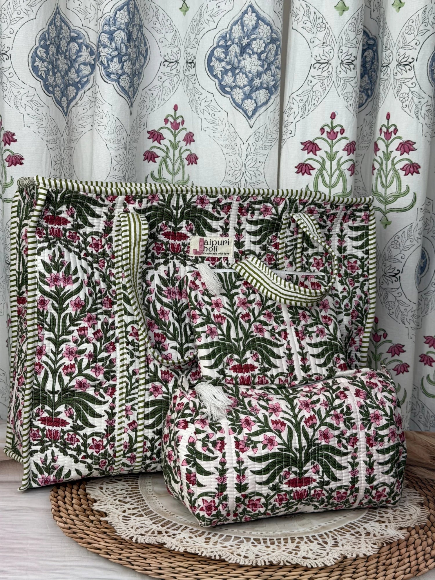 Jaipur block print cotton quilted large zip tote bag with matching toiletry pouch and flat pouch, pink floral and green leaf print, 18 × 18 × 6 inch tote, 10 × 6 inch toiletry pouch and 9 × 7 inch flat pouch side view