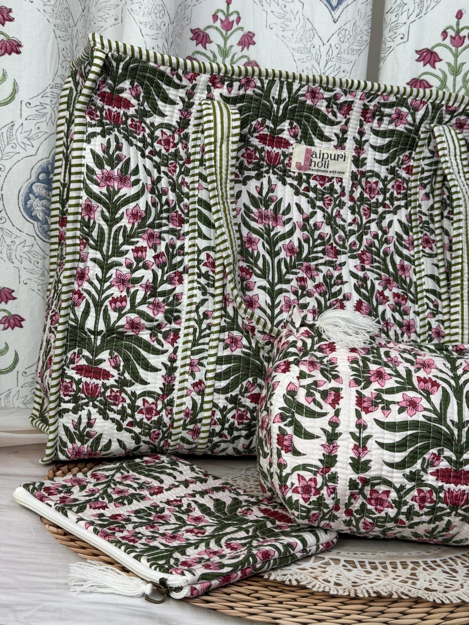 Jaipur block print cotton quilted large zip tote bag with matching toiletry pouch and flat pouch, pink floral and green leaf print, 18 × 18 × 6 inch tote, 10 × 6 inch toiletry pouch and 9 × 7 inch flat pouch close-up view