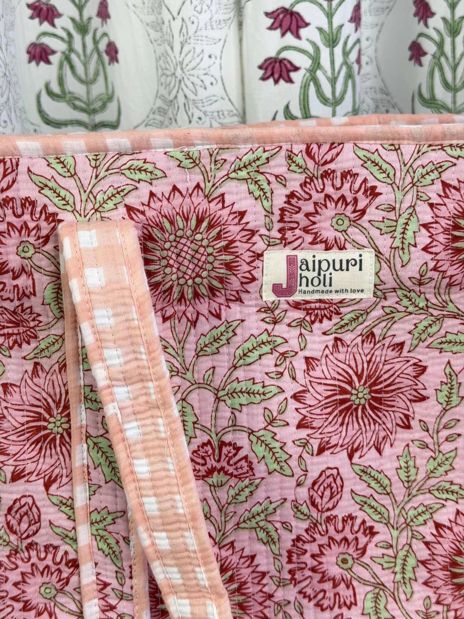 Jaipur block print cotton quilted large tote bag with matching pouch, peach and pink floral print, 18x18x6 inch tote with 10x6 inch pouch for keeping toiletries and cosmetics in one place close-up view