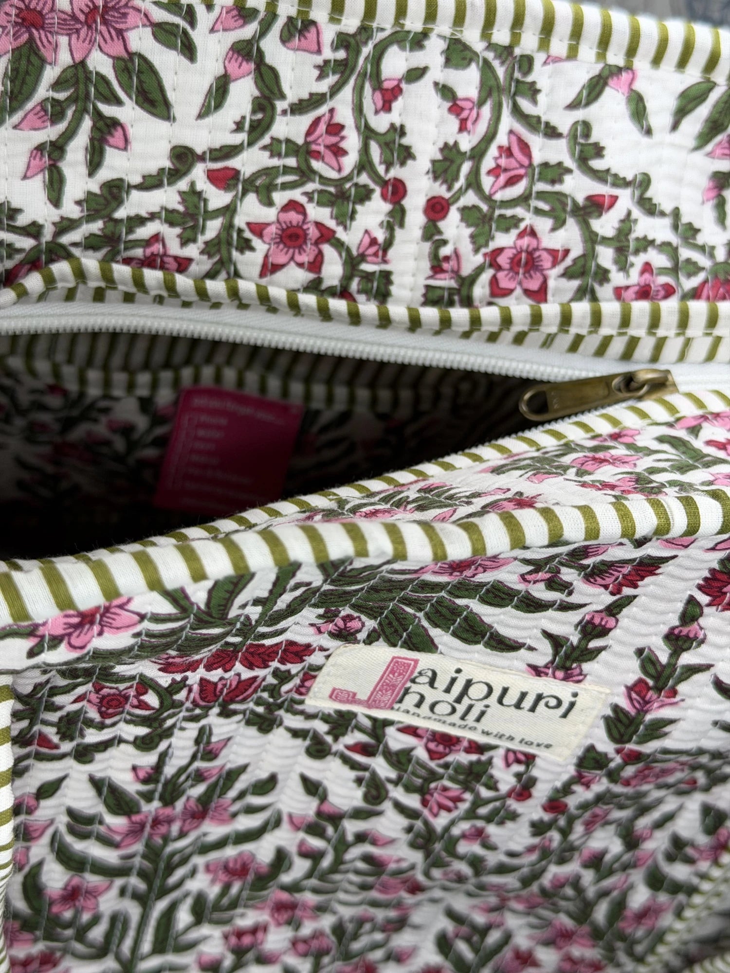 Jaipur block print cotton quilted large tote bag with matching pouch, pink floral and green leaf print, 18x18x6 inch tote with 10x6 inch pouch for storing toiletries and everyday travel items close-up view