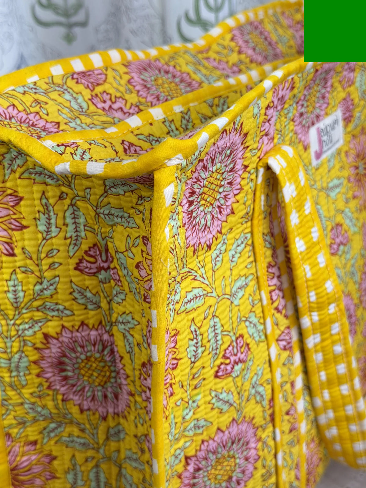 Jaipur block print cotton quilted large tote bag with matching pouch, yellow floral print, 18x18x6 inch tote with 10x6 inch pouch for keeping toiletries, cosmetics and travel necessities organized close-up view