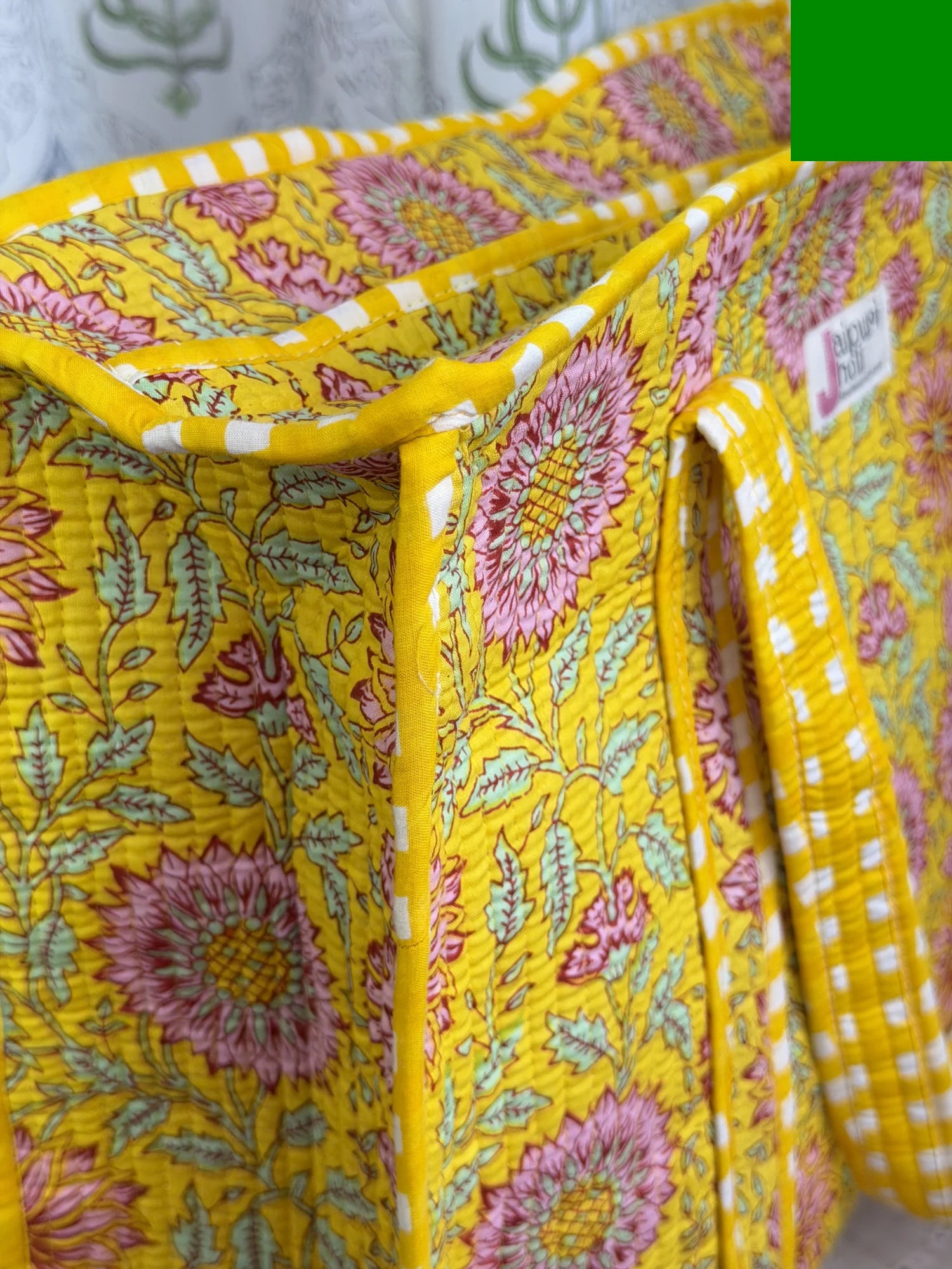 Jaipur block print cotton quilted large tote bag with matching pouch, yellow floral print, 18x18x6 inch tote with 10x6 inch pouch for keeping toiletries, cosmetics and travel necessities organized close-up view