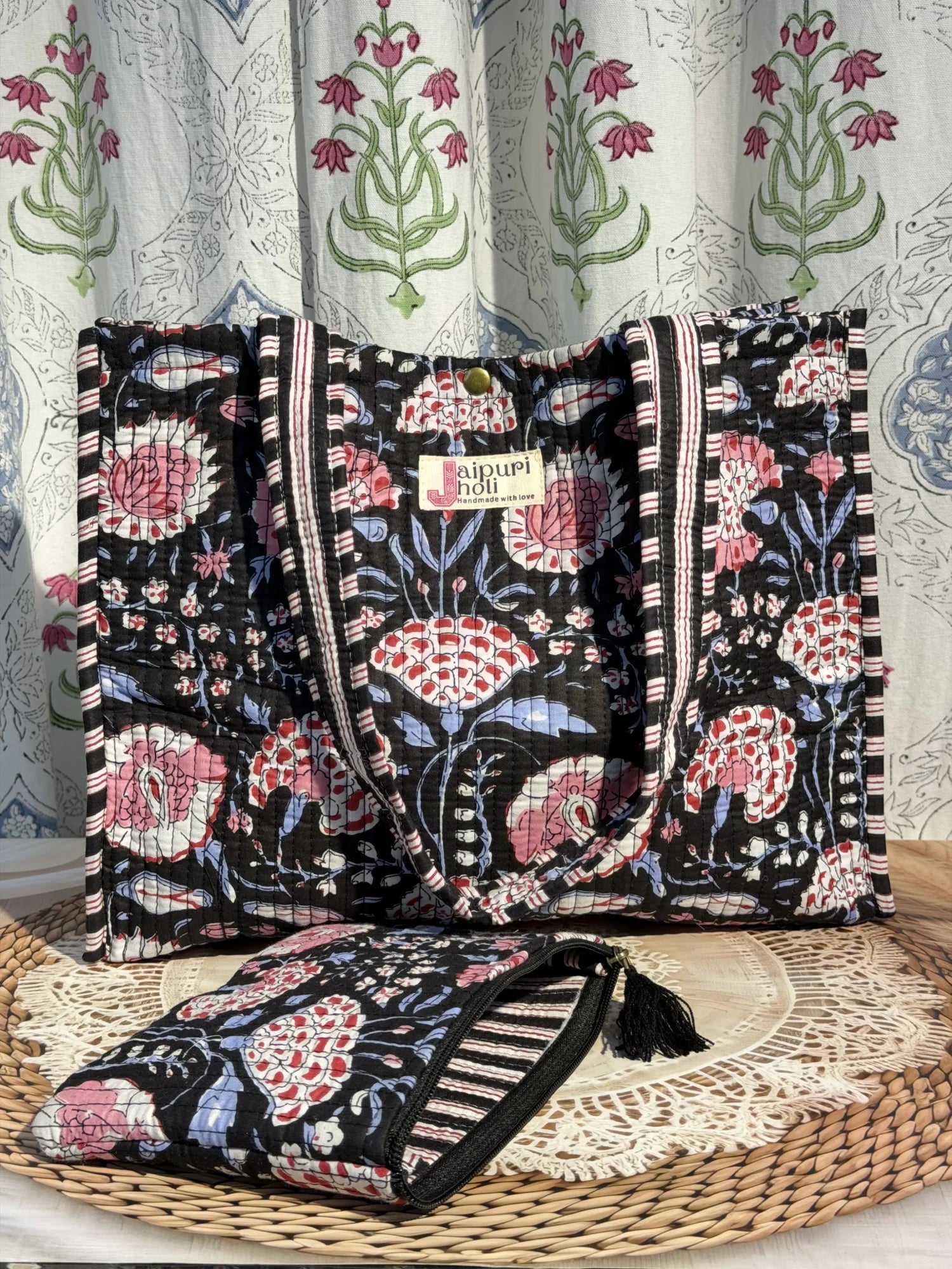 Jaipur block print cotton quilted medium reversible tote bag with matching flat pouch, black and pink floral print, 15 × 12 × 6 inch tote and 9 × 7 inch flat pouch for work, shopping and travel side view