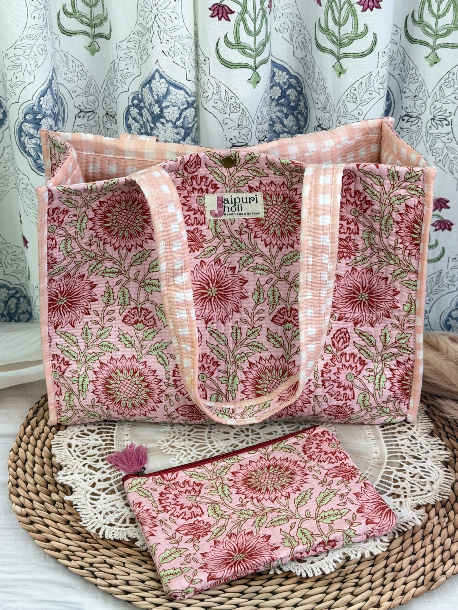 Jaipur block print cotton quilted medium reversible tote bag with matching flat pouch, peach and pink floral print, 15 × 12 × 6 inch tote and 9 × 7 inch flat pouch for shopping, travel and everyday use front view