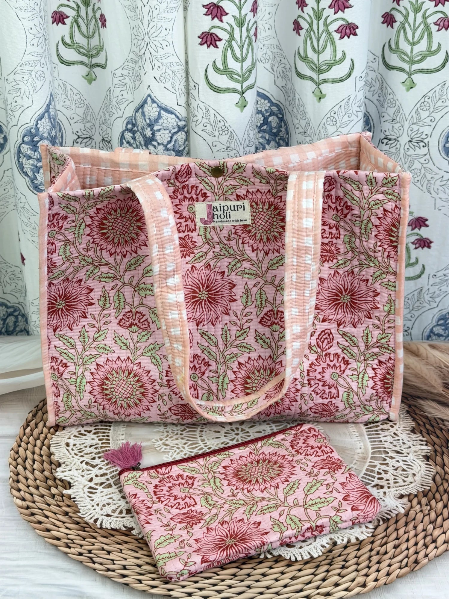 Jaipur block print cotton quilted medium reversible tote bag with matching flat pouch, peach and pink floral print, 15 × 12 × 6 inch tote and 9 × 7 inch flat pouch for shopping, travel and everyday use side view
