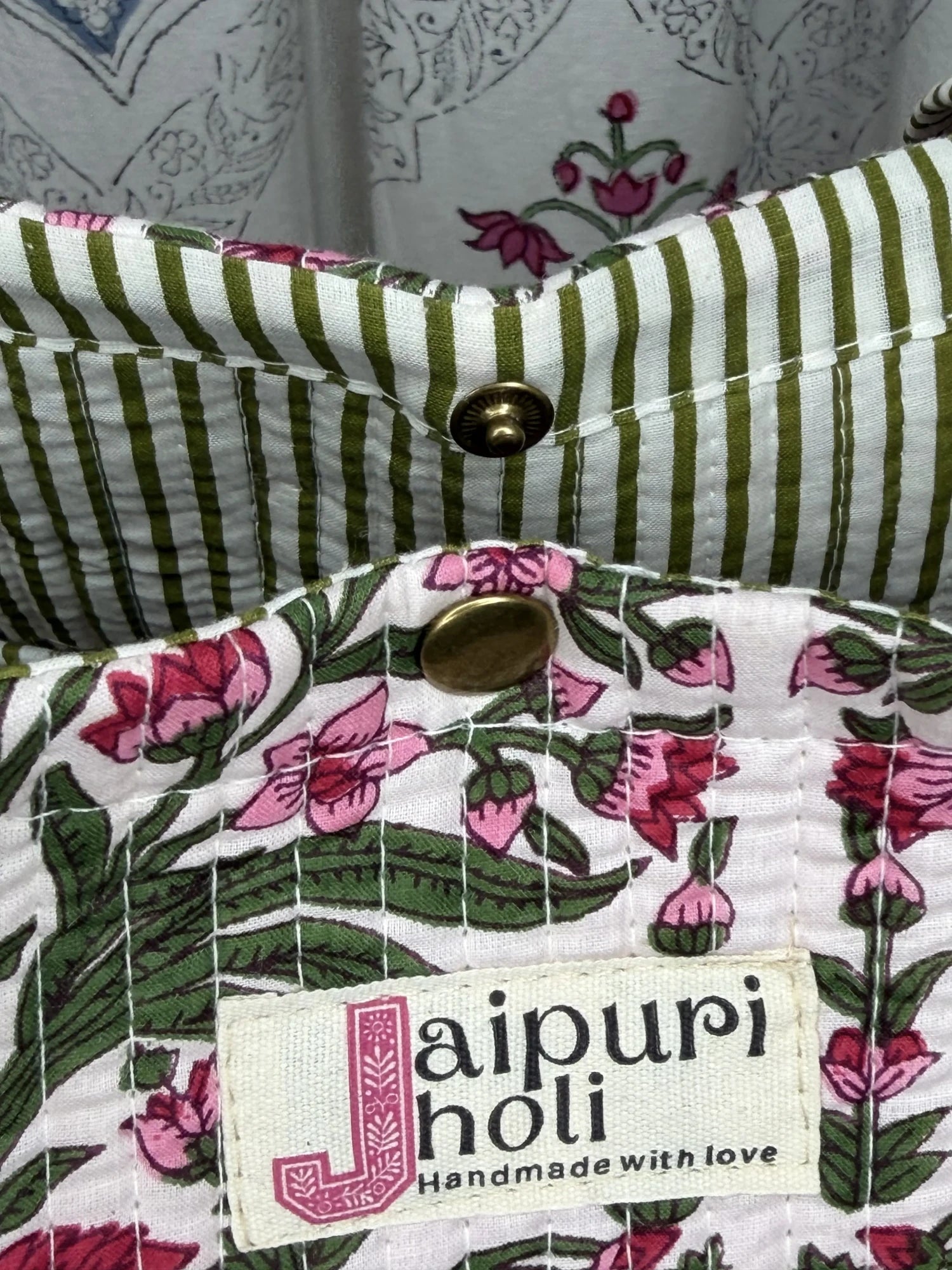 Jaipur block print cotton quilted medium reversible tote bag with matching flat pouch, pink floral and green leaf print, 15 × 12 × 6 inch tote and 9 × 7 inch flat pouch for travel, shopping and work close-up view