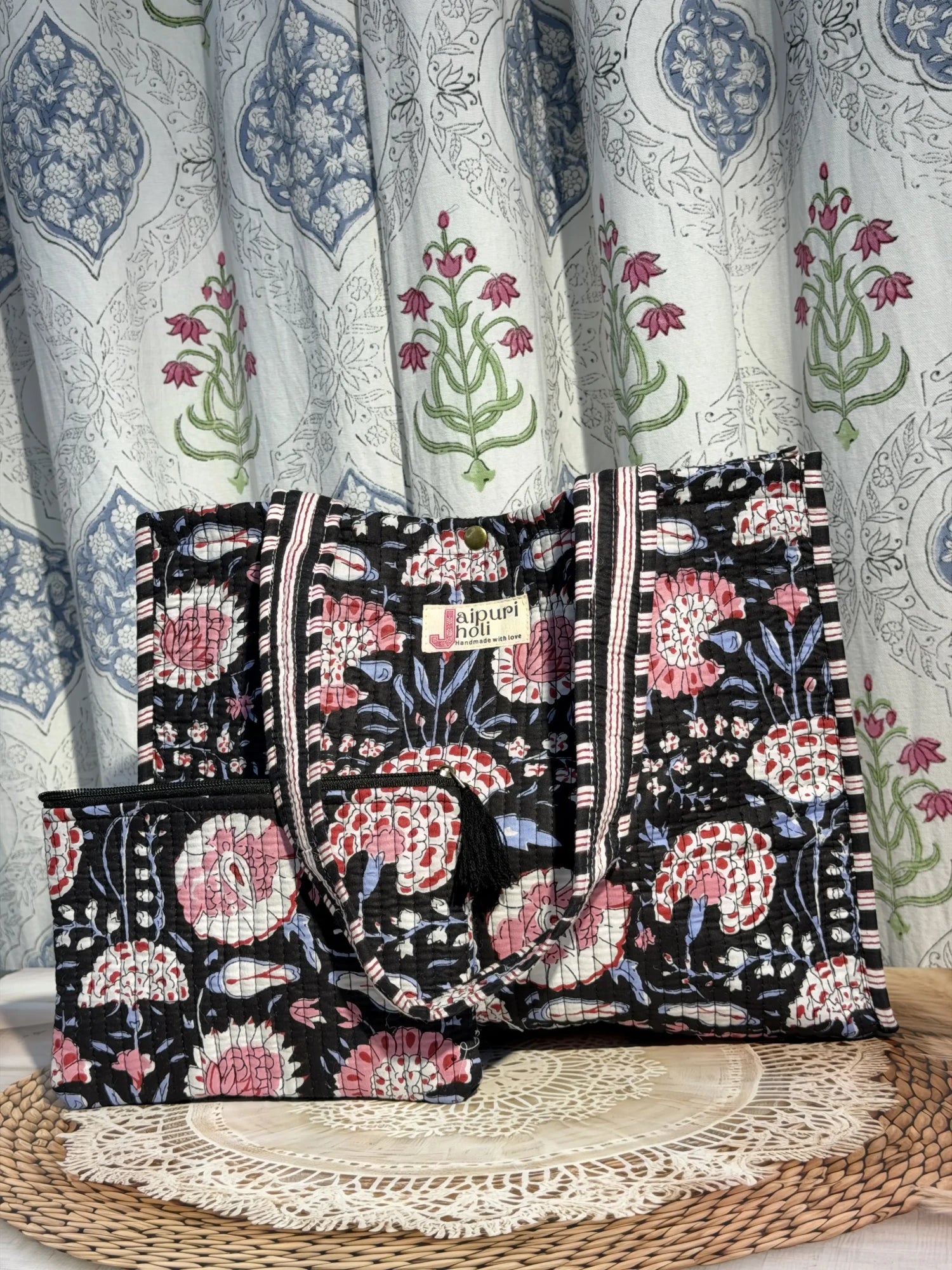Jaipur block print medium cotton quilted reversible tote bag with matching toiletry pouch and flat pouch, black and pink floral print, 15 × 12 × 6 inch tote with button closure, 10 × 6 inch toiletry pouch and 9 × 7 inch flat pouch back view