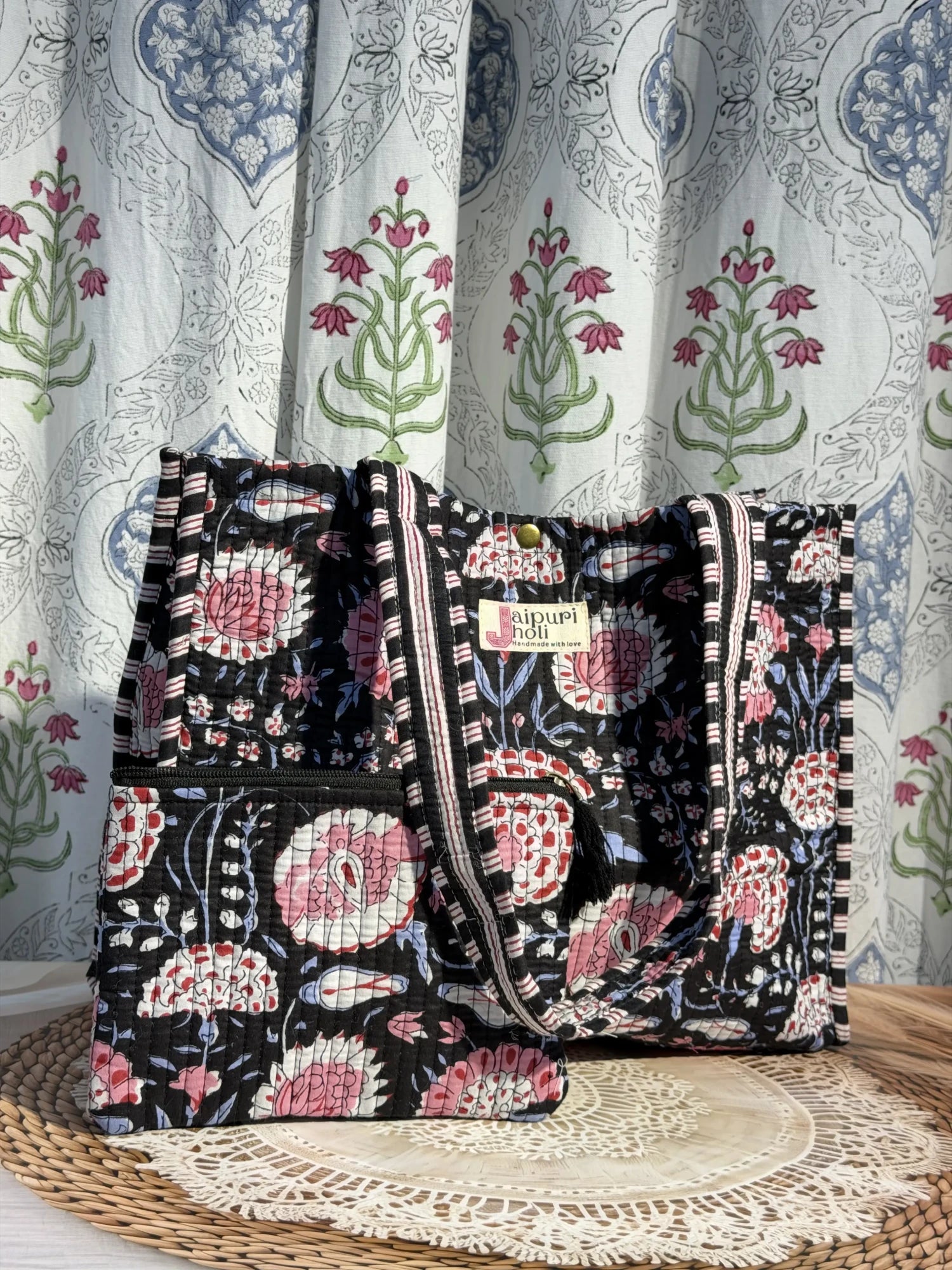 Jaipur block print medium cotton quilted reversible tote bag with matching toiletry pouch and flat pouch, black and pink floral print, 15 × 12 × 6 inch tote with button closure, 10 × 6 inch toiletry pouch and 9 × 7 inch flat pouch interior view