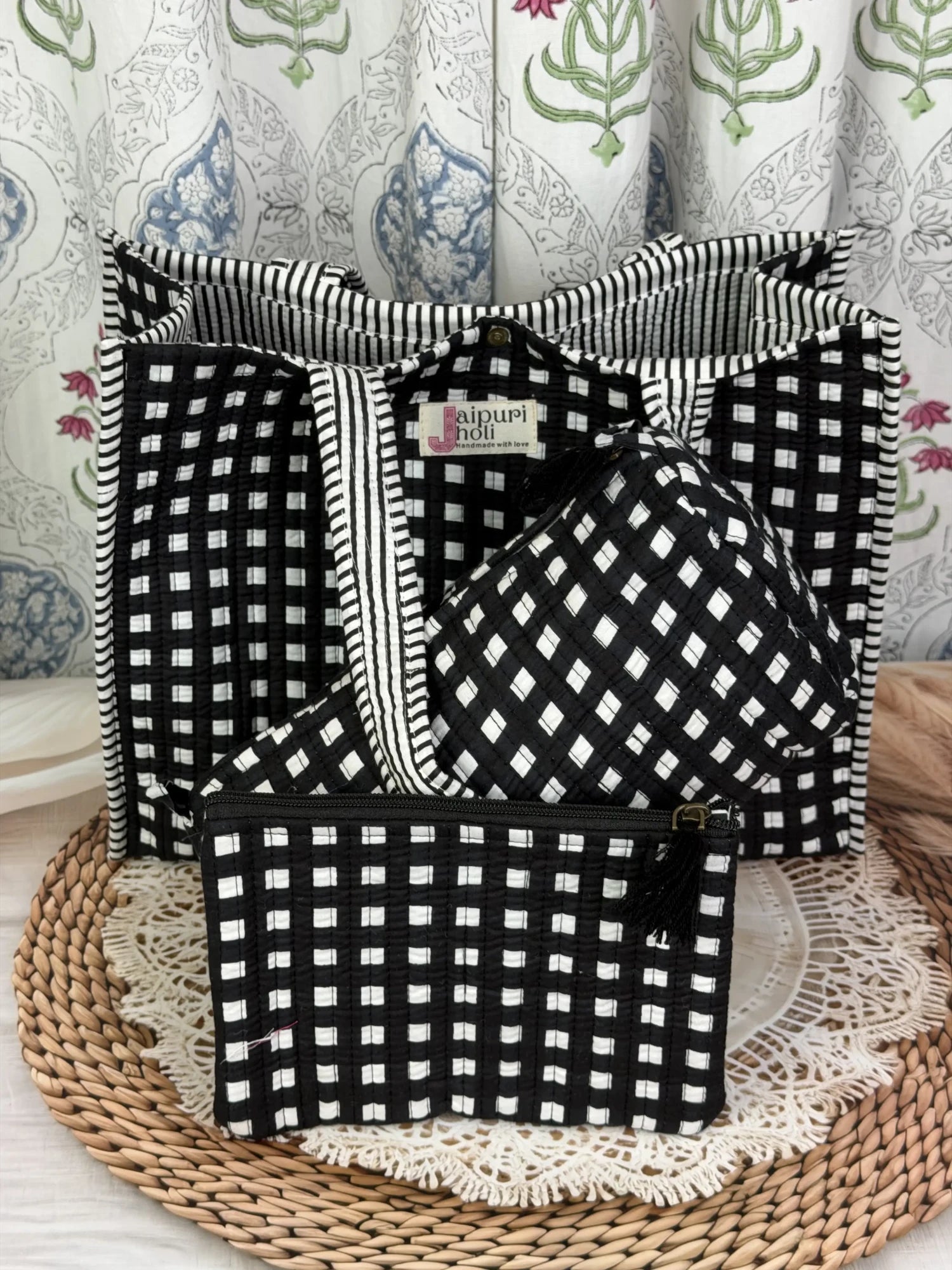 Jaipur block print medium cotton quilted reversible tote bag with matching toiletry pouch and flat pouch, black and white geometric check print, 15 × 12 × 6 inch tote with button closure, 10 × 6 inch toiletry pouch and 9 × 7 inch flat pouch front view