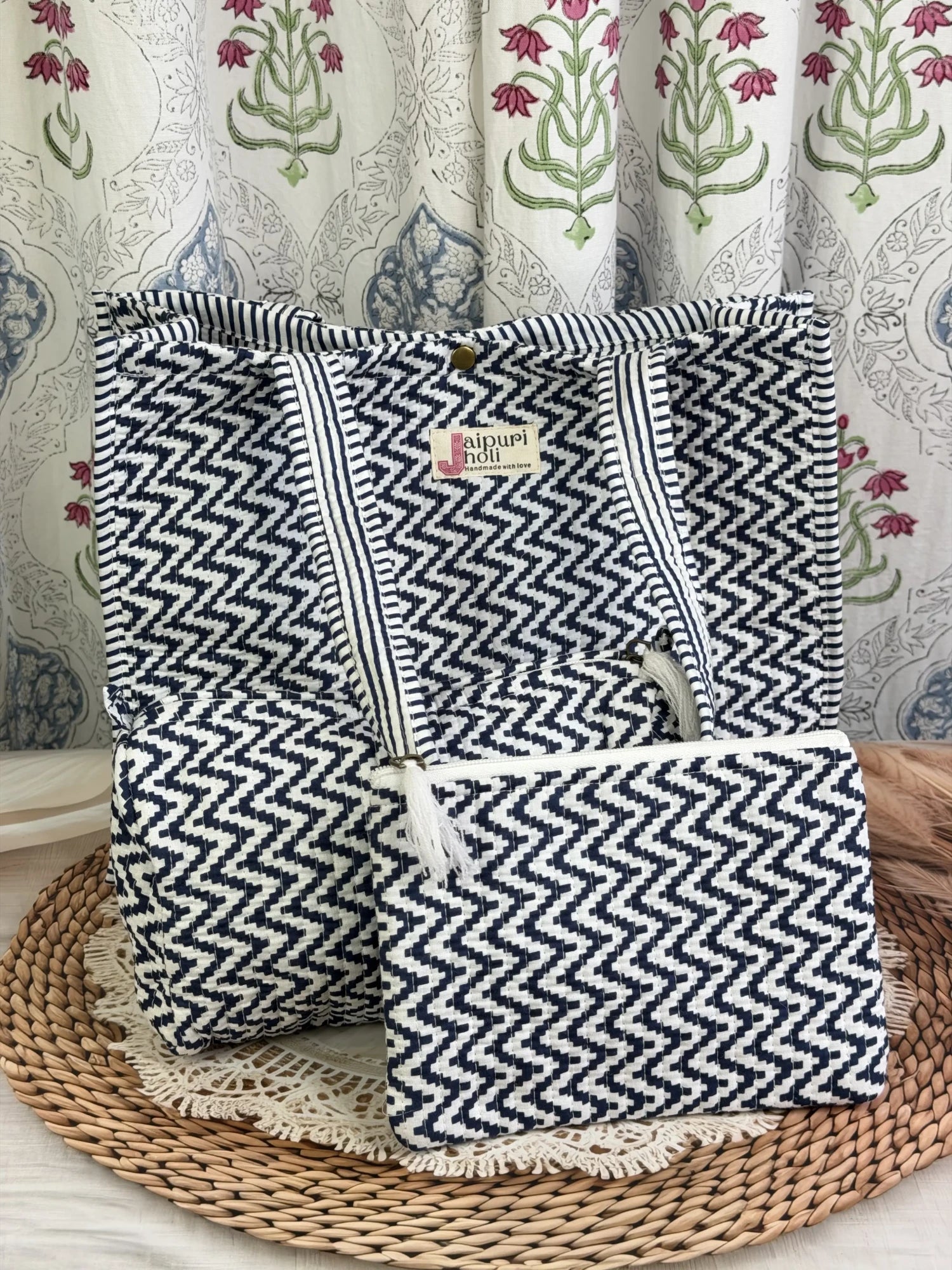 Jaipur block print medium cotton quilted reversible tote bag with matching toiletry pouch and flat pouch, blue and white geometric zigzag print, 15 × 12 × 6 inch tote with button closure, 10 × 6 inch toiletry pouch and 9 × 7 inch flat pouch back view