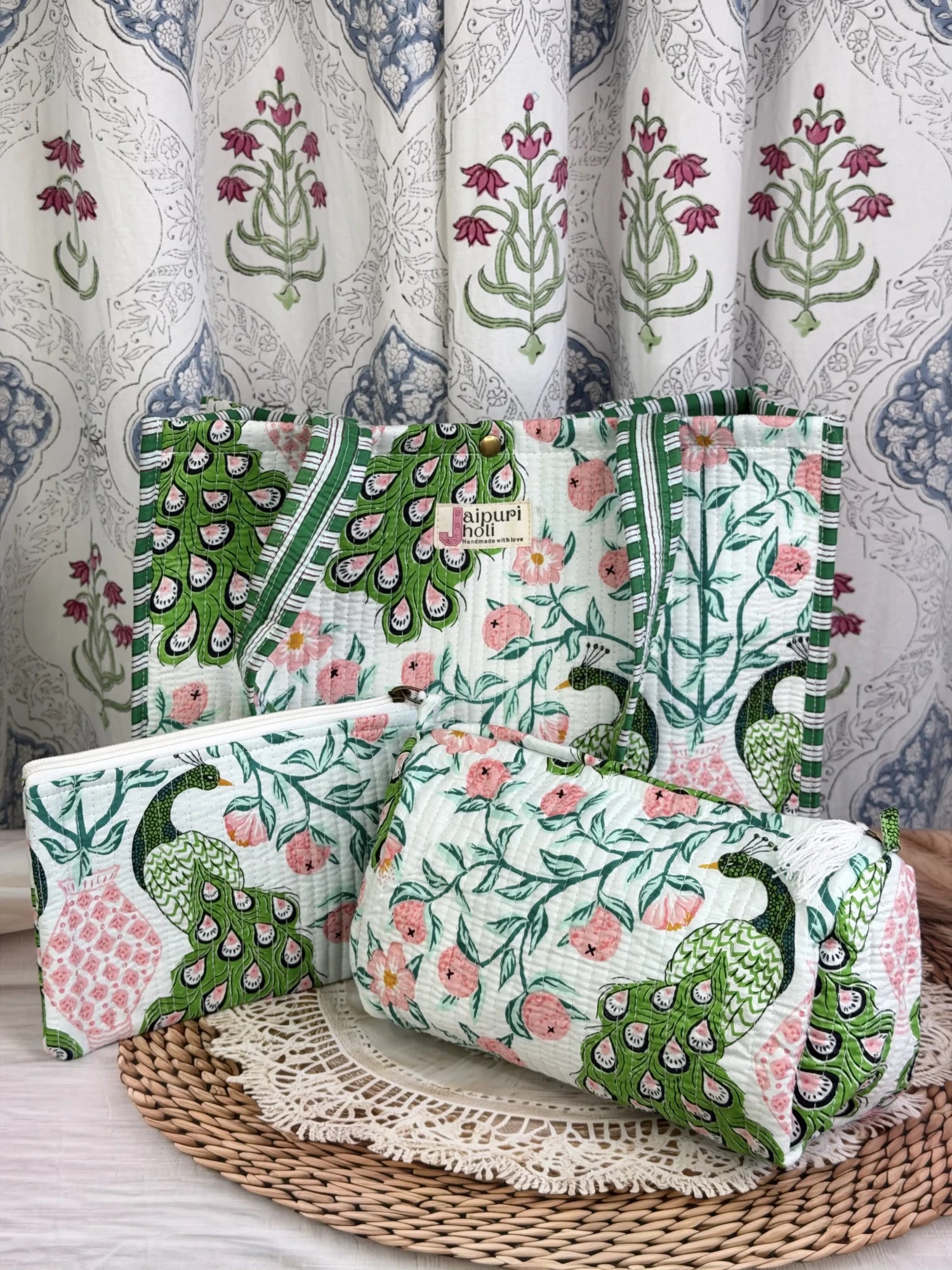Jaipur block print medium cotton quilted reversible tote bag with matching toiletry pouch and flat pouch, green and pink peacock print, 15 × 12 × 6 inch tote with button closure, 10 × 6 inch toiletry pouch and 9 × 7 inch flat pouchside view