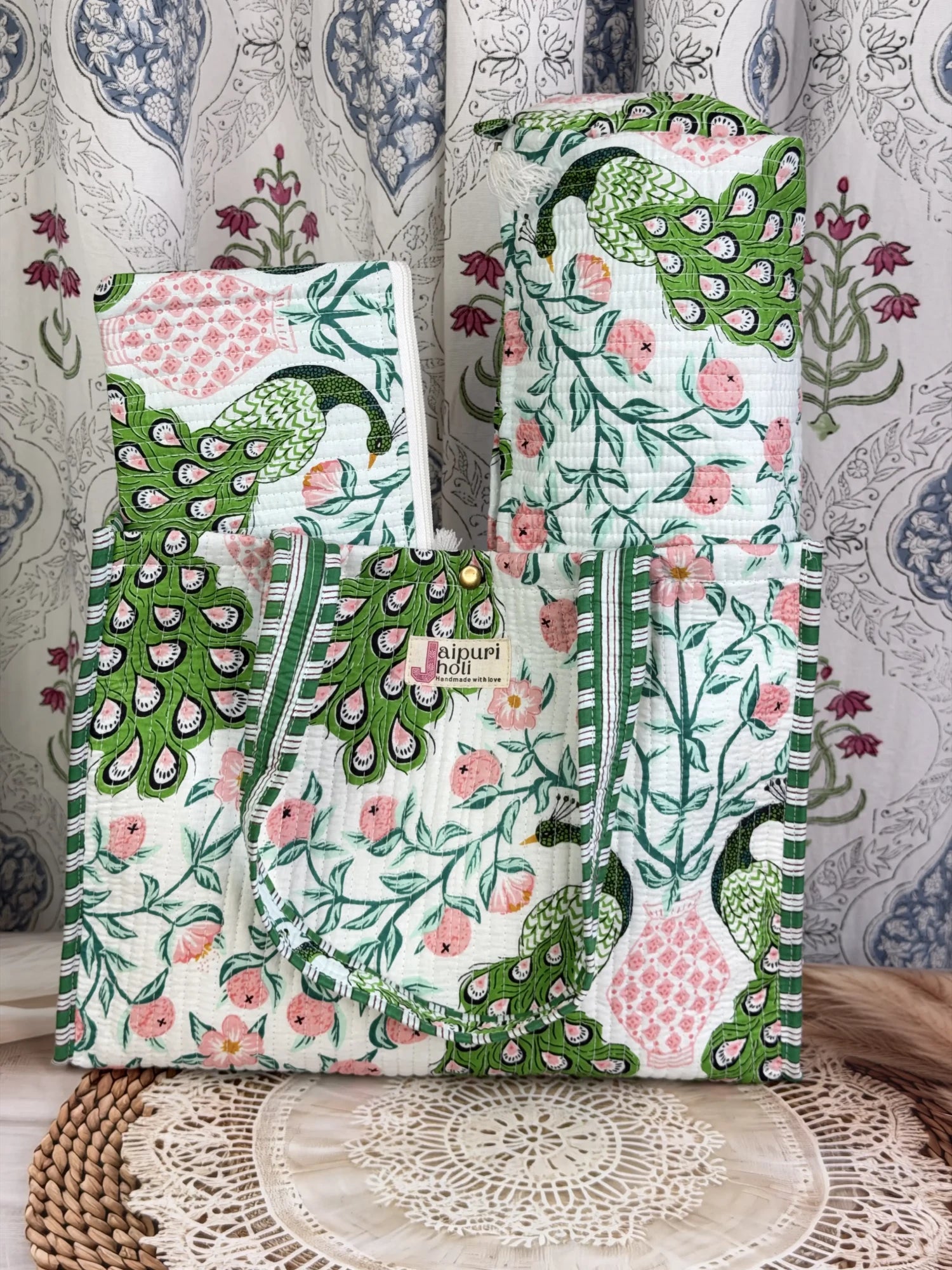 Jaipur block print medium cotton quilted reversible tote bag with matching toiletry pouch and flat pouch, green and pink peacock print, 15 × 12 × 6 inch tote with button closure, 10 × 6 inch toiletry pouch and 9 × 7 inch flat pouch close-up view