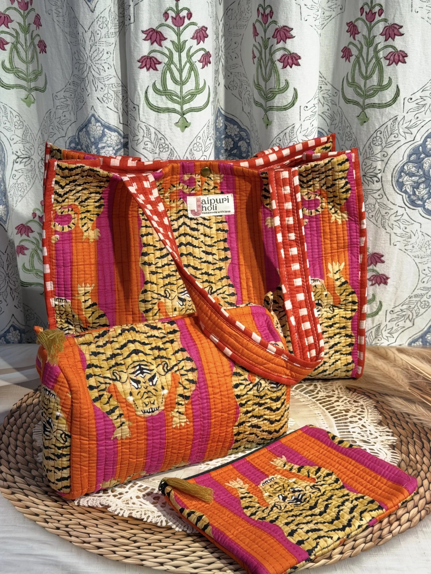 Jaipur block print medium cotton quilted reversible tote bag with matching toiletry pouch and flat pouch, orange and pink tiger print, 15 × 12 × 6 inch tote with button closure, 10 × 6 inch toiletry pouch and 9 × 7 inch flat pouch interior view