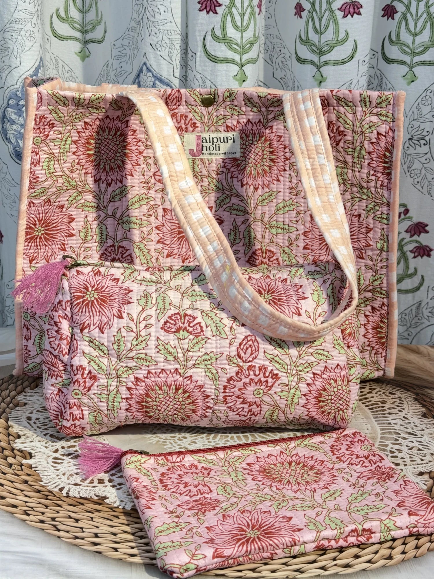Jaipur block print medium cotton quilted reversible tote bag with matching toiletry pouch and flat pouch, peach and pink floral print, 15 × 12 × 6 inch tote with button closure, 10 × 6 inch toiletry pouch and 9 × 7 inch flat pouch back view