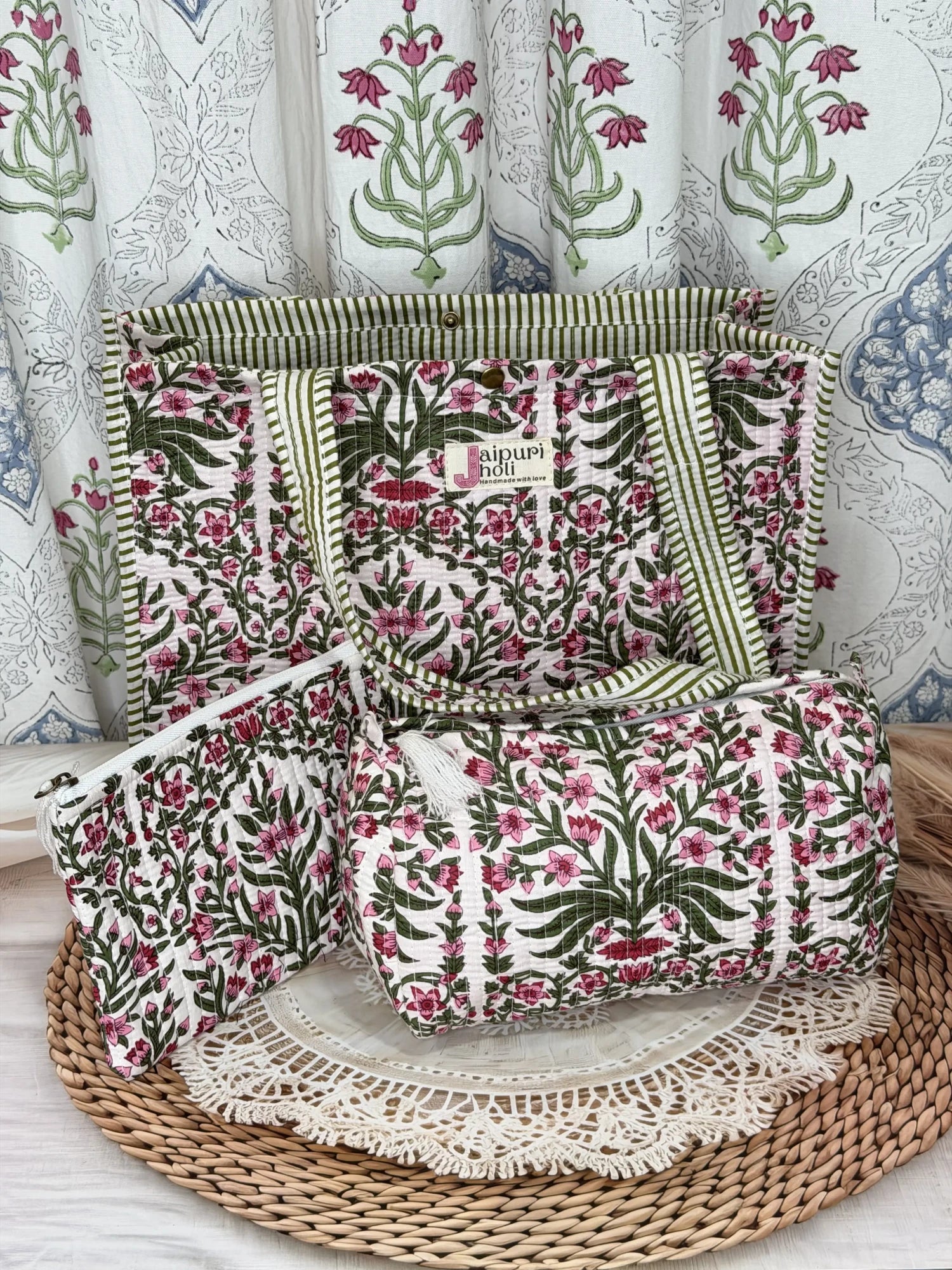 Jaipur block print medium cotton quilted reversible tote bag with matching toiletry pouch and flat pouch, pink floral and green leaf print, 15 × 12 × 6 inch tote with button closure, 10 × 6 inch toiletry pouch and 9 × 7 inch flat pouch back view