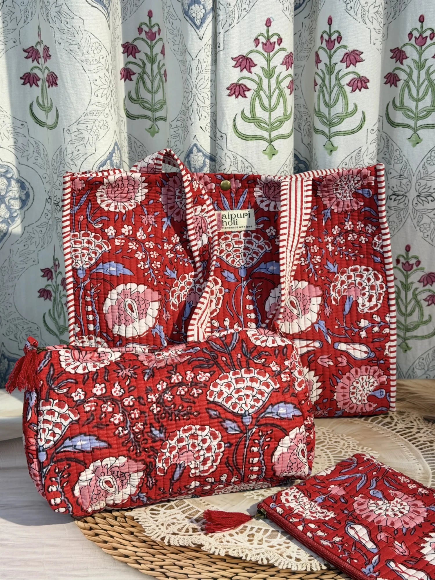 Jaipur block print medium cotton quilted reversible tote bag with matching toiletry pouch and flat pouch, red floral print, 15 × 12 × 6 inch tote with button closure, 10 × 6 inch toiletry pouch and 9 × 7 inch flat pouch back view