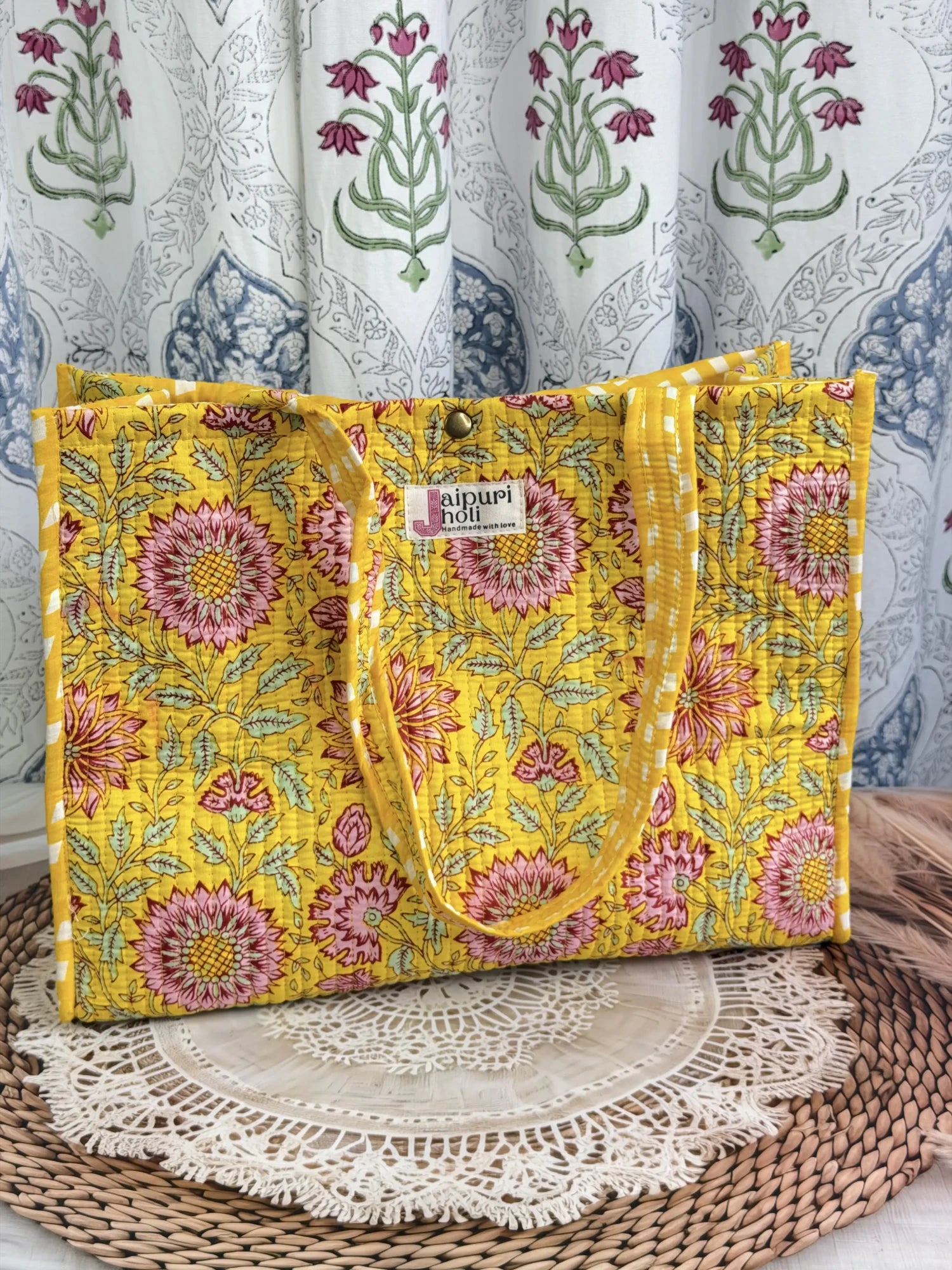 Jaipur block print medium cotton quilted reversible tote bag with matching toiletry pouch and flat pouch, yellow floral print, 15 × 12 × 6 inch tote with button closure, 10 × 6 inch toiletry pouch and 9 × 7 inch flat pouch back view