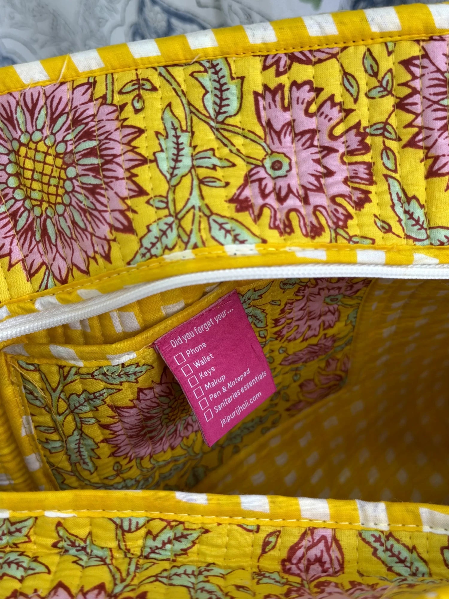 Jaipur block print cotton quilted medium zip tote bag with matching flat pouch, yellow floral print, 15 × 12 × 6 inch tote with 9 × 7 inch flat pouch for work, travel and everyday use close-up view