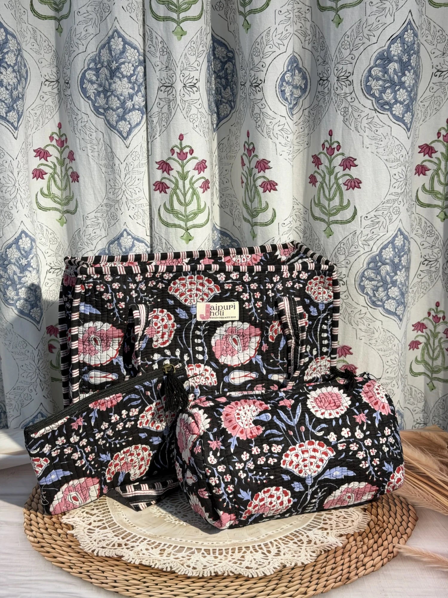 Jaipur block print medium cotton quilted zip tote bag with matching toiletry pouch and flat pouch, black and pink floral print, 15 × 12 × 6 inch tote, 10 × 6 inch toiletry pouch and 9 × 7 inch flat pouch front view