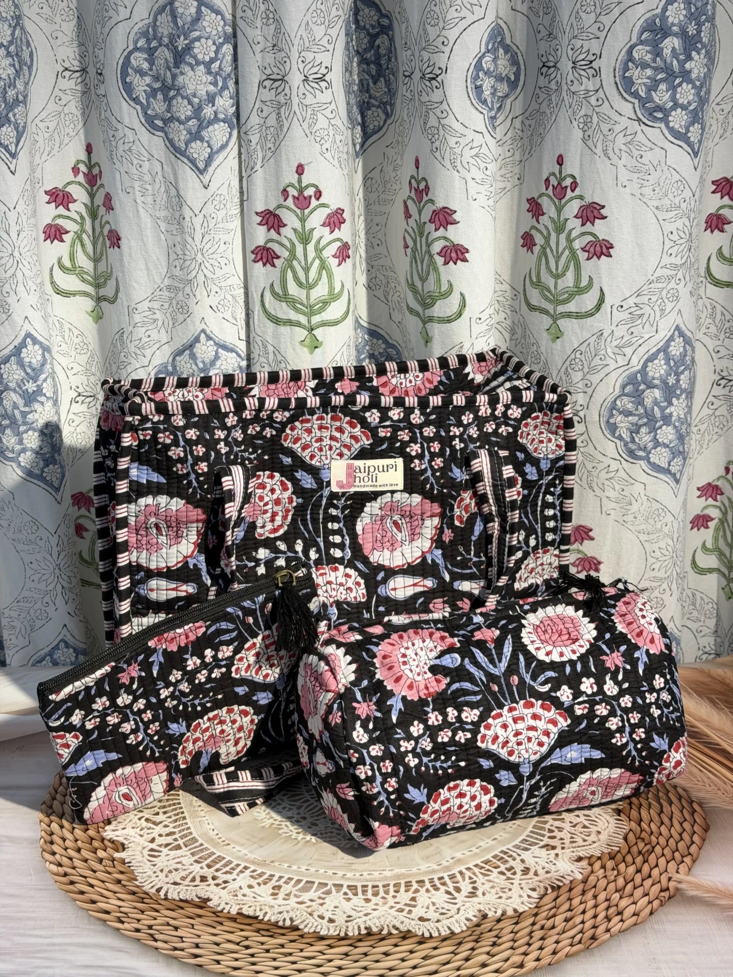 Jaipur block print medium cotton quilted zip tote bag with matching toiletry pouch and flat pouch, black and pink floral print, 15 × 12 × 6 inch tote, 10 × 6 inch toiletry pouch and 9 × 7 inch flat pouch side view