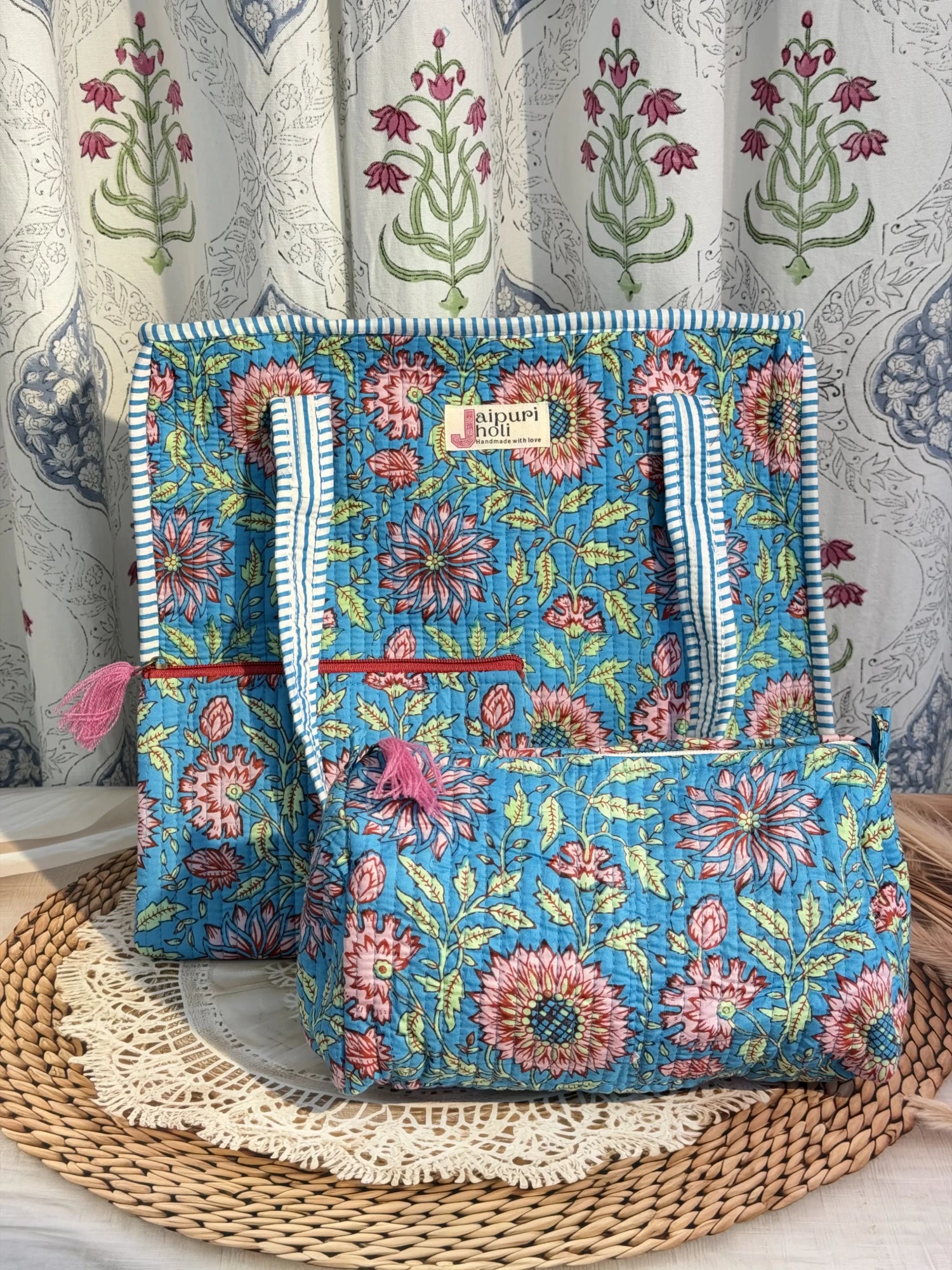 Jaipur block print medium cotton quilted zip tote bag with matching toiletry pouch and flat pouch, blue floral print, 15 × 12 × 6 inch tote, 10 × 6 inch toiletry pouch and 9 × 7 inch flat pouch side view