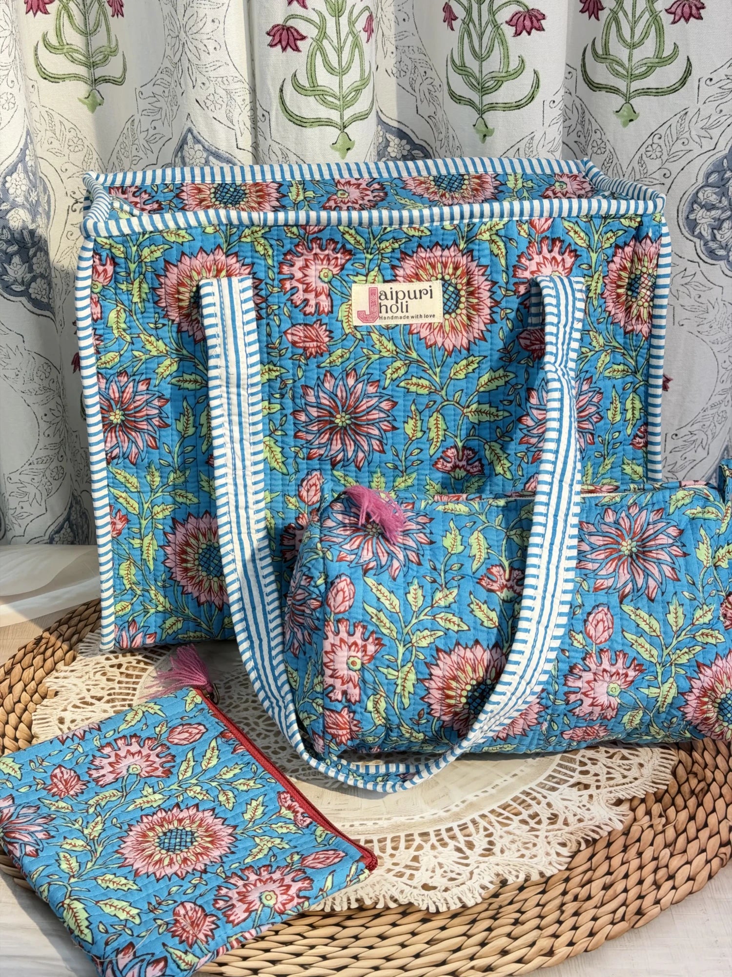 Jaipur block print medium cotton quilted zip tote bag with matching toiletry pouch and flat pouch, blue floral print, 15 × 12 × 6 inch tote, 10 × 6 inch toiletry pouch and 9 × 7 inch flat pouch back view