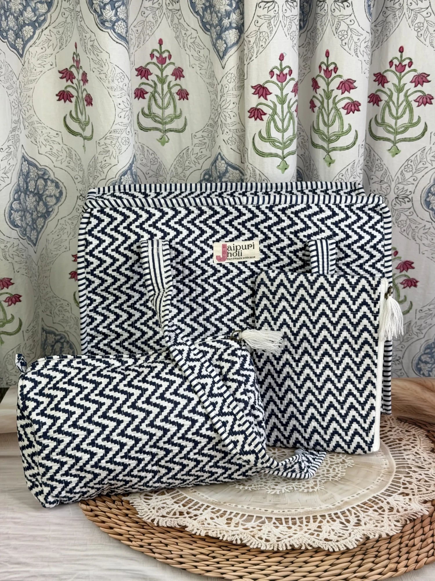Jaipur block print medium cotton quilted zip tote bag with matching toiletry pouch and flat pouch, blue and white geometric zigzag print, 15 × 12 × 6 inch tote, 10 × 6 inch toiletry pouch and 9 × 7 inch flat pouch front view