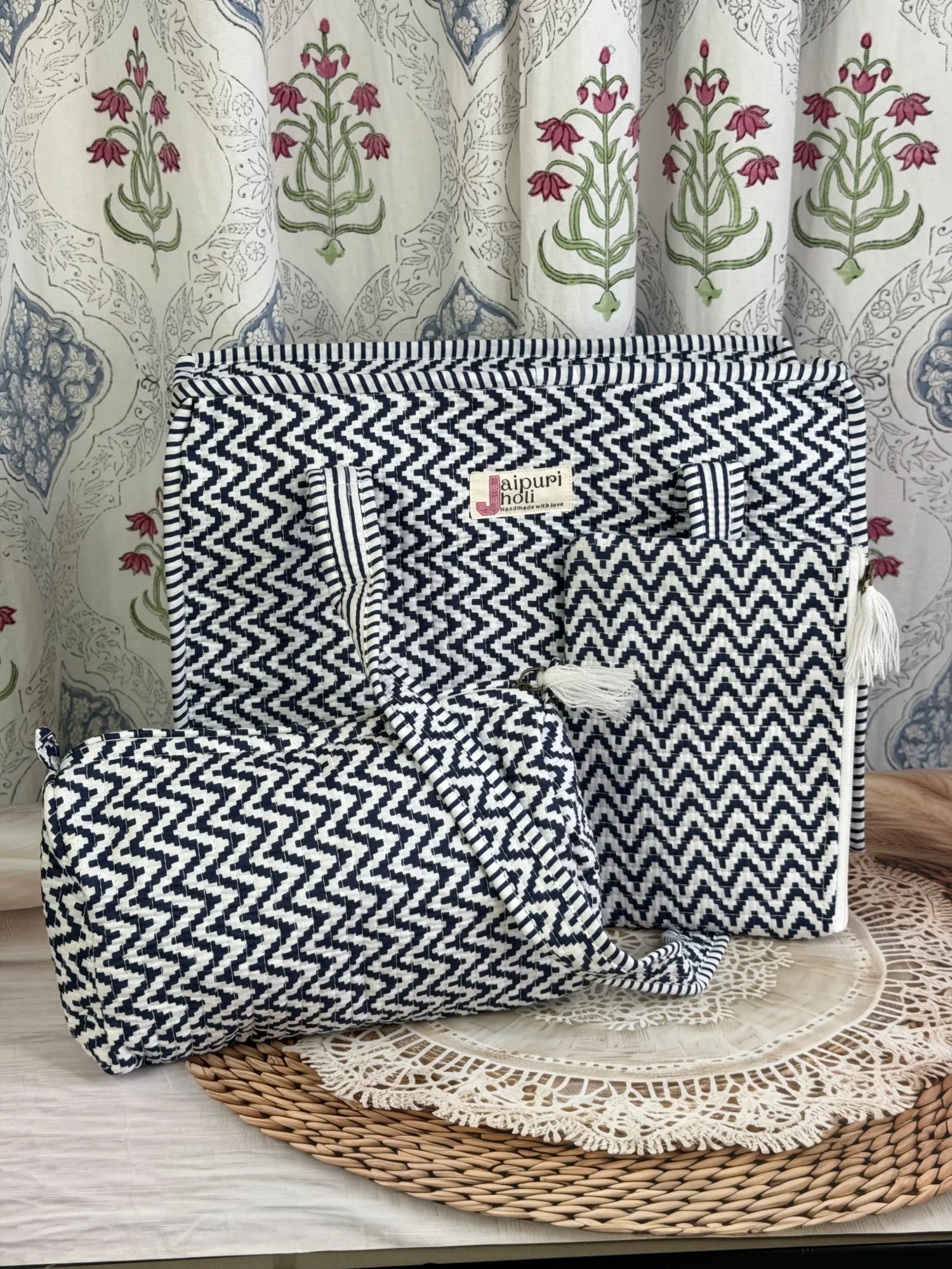 Jaipur block print medium cotton quilted zip tote bag with matching toiletry pouch and flat pouch, blue and white geometric zigzag print, 15 × 12 × 6 inch tote, 10 × 6 inch toiletry pouch and 9 × 7 inch flat pouch side view