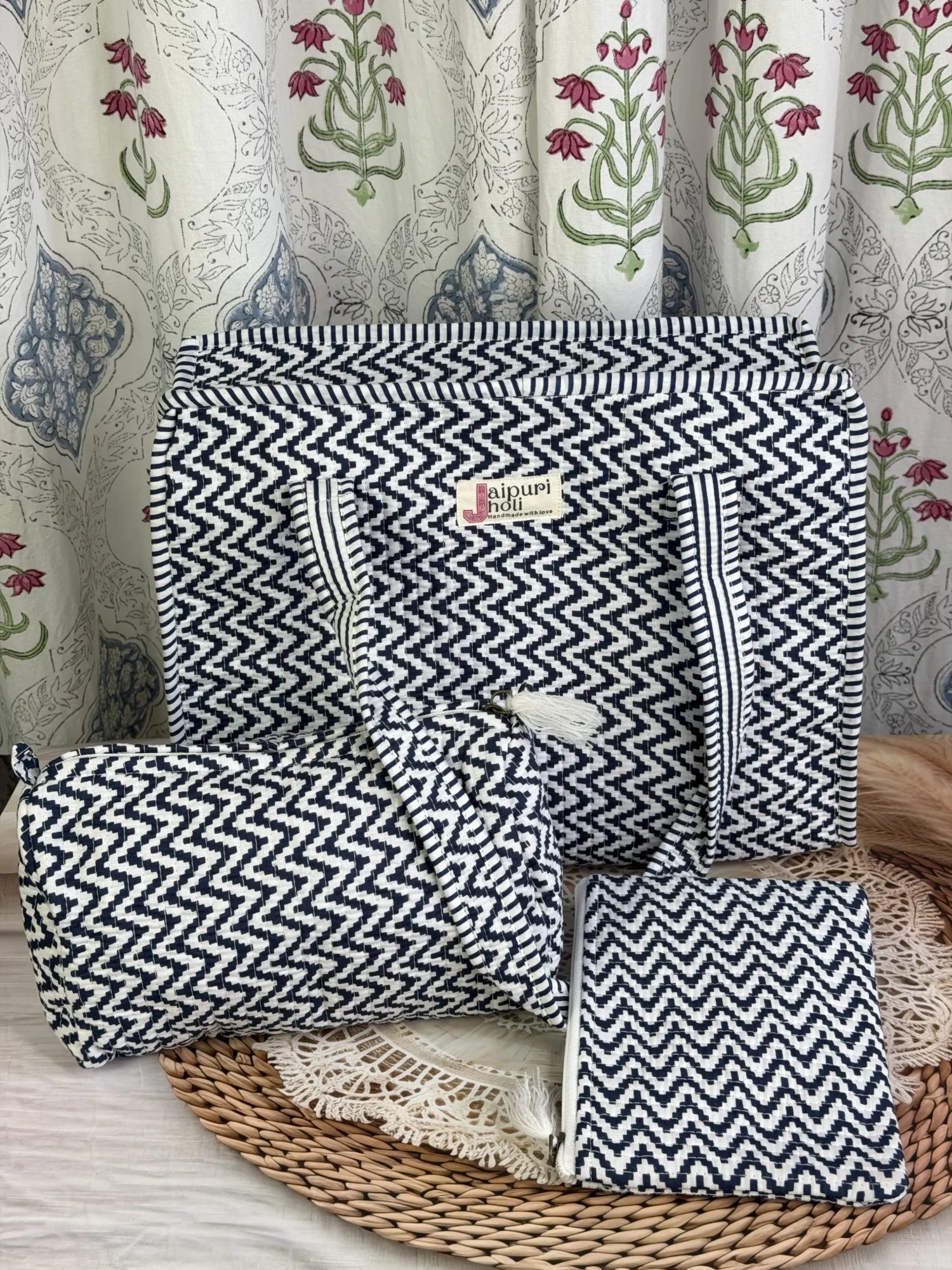 Jaipur block print medium cotton quilted zip tote bag with matching toiletry pouch and flat pouch, blue and white geometric zigzag print, 15 × 12 × 6 inch tote, 10 × 6 inch toiletry pouch and 9 × 7 inch flat pouch back view