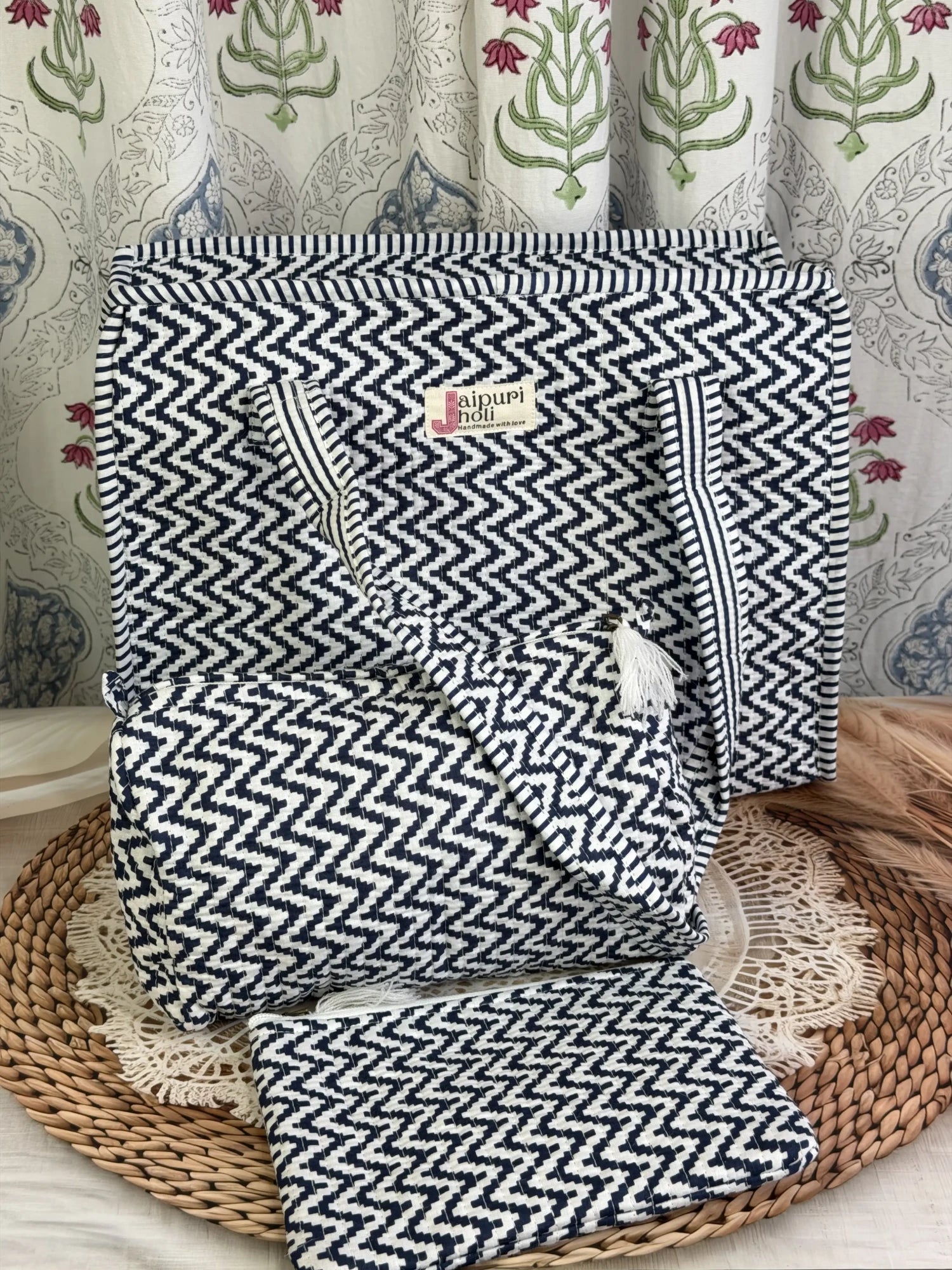 Jaipur block print medium cotton quilted zip tote bag with matching toiletry pouch and flat pouch, blue and white geometric zigzag print, 15 × 12 × 6 inch tote, 10 × 6 inch toiletry pouch and 9 × 7 inch flat pouch close-up view