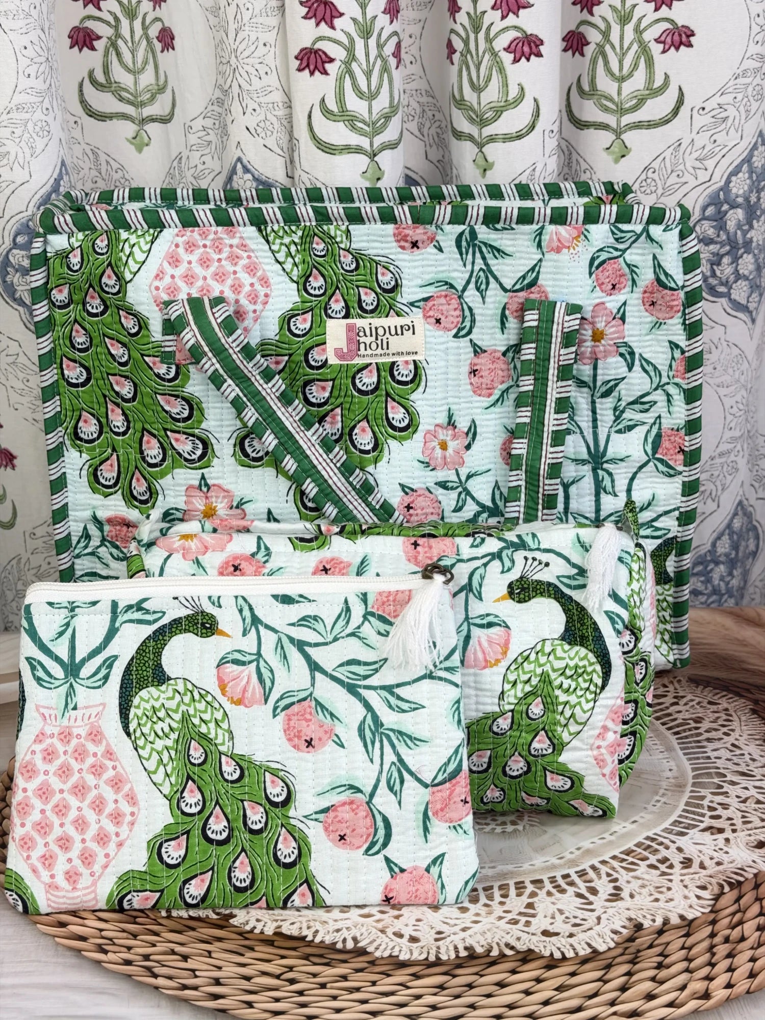 Jaipur block print medium cotton quilted zip tote bag with matching toiletry pouch and flat pouch, green and pink peacock print, 15 × 12 × 6 inch tote, 10 × 6 inch toiletry pouch and 9 × 7 inch flat pouch front view