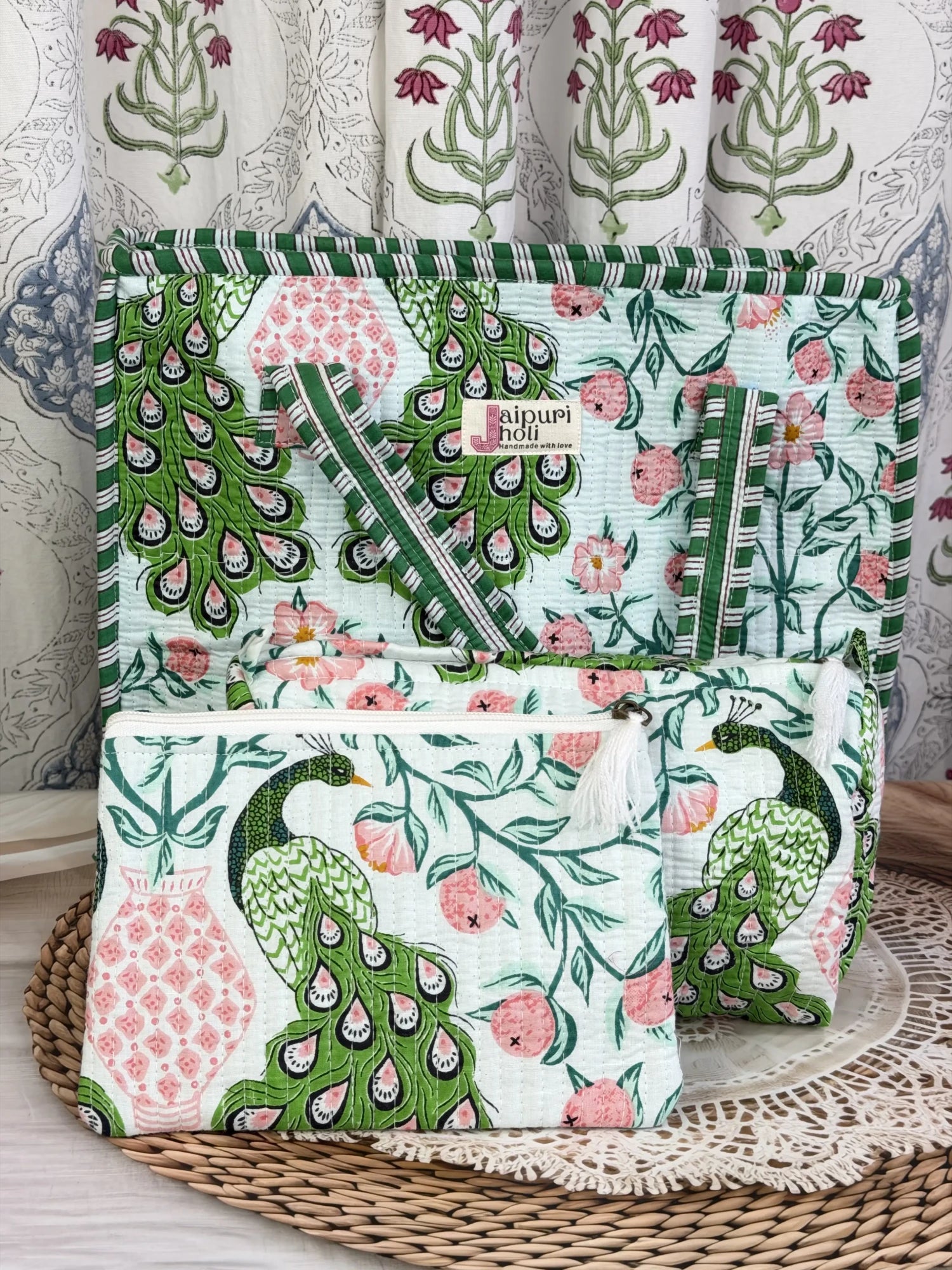 Jaipur block print medium cotton quilted zip tote bag with matching toiletry pouch and flat pouch, green and pink peacock print, 15 × 12 × 6 inch tote, 10 × 6 inch toiletry pouch and 9 × 7 inch flat pouch side view