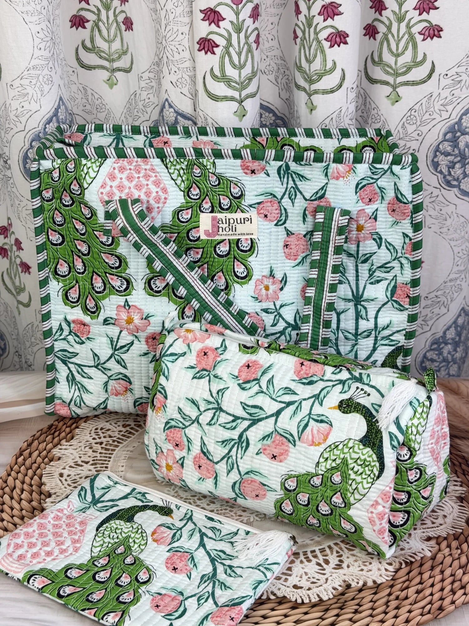 Jaipur block print medium cotton quilted zip tote bag with matching toiletry pouch and flat pouch, green and pink peacock print, 15 × 12 × 6 inch tote, 10 × 6 inch toiletry pouch and 9 × 7 inch flat pouch close-up view
