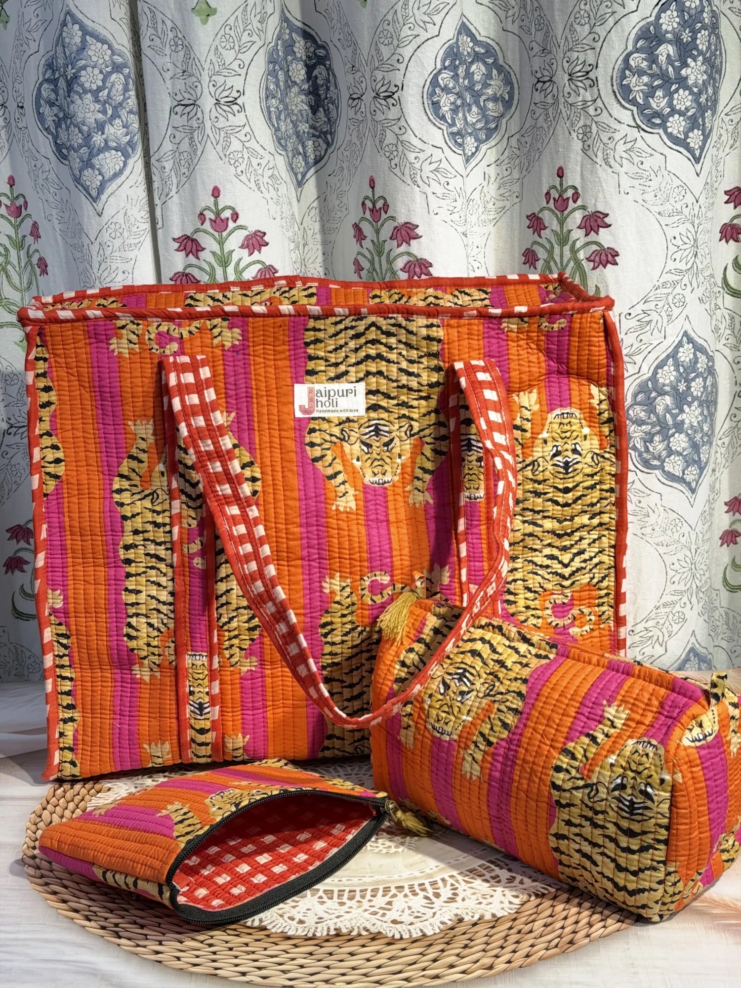 Jaipur block print medium cotton quilted reversible tote bag with matching toiletry pouch and flat pouch, orange and pink tiger print, 15 × 12 × 6 inch tote with button closure, 10 × 6 inch toiletry pouch and 9 × 7 inch flat pouch back view