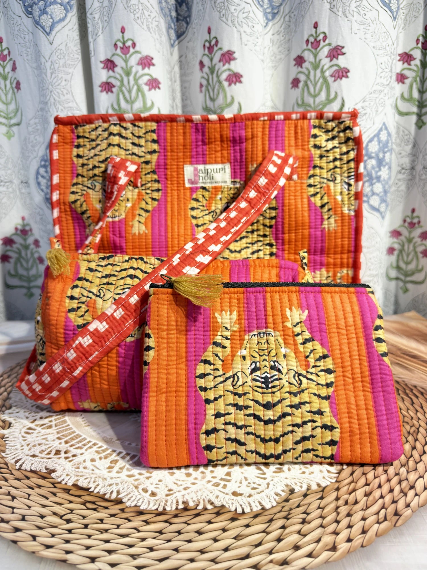 Jaipur block print medium cotton quilted reversible tote bag with matching toiletry pouch and flat pouch, orange and pink tiger print, 15 × 12 × 6 inch tote with button closure, 10 × 6 inch toiletry pouch and 9 × 7 inch flat pouch interior view
