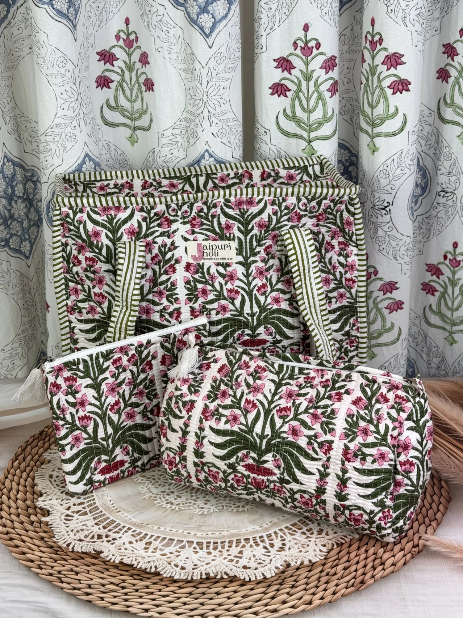 Jaipur block print medium cotton quilted zip tote bag with matching toiletry pouch and flat pouch, pink floral and green leaf print, 15 × 12 × 6 inch tote, 10 × 6 inch toiletry pouch and 9 × 7 inch flat pouch side view
