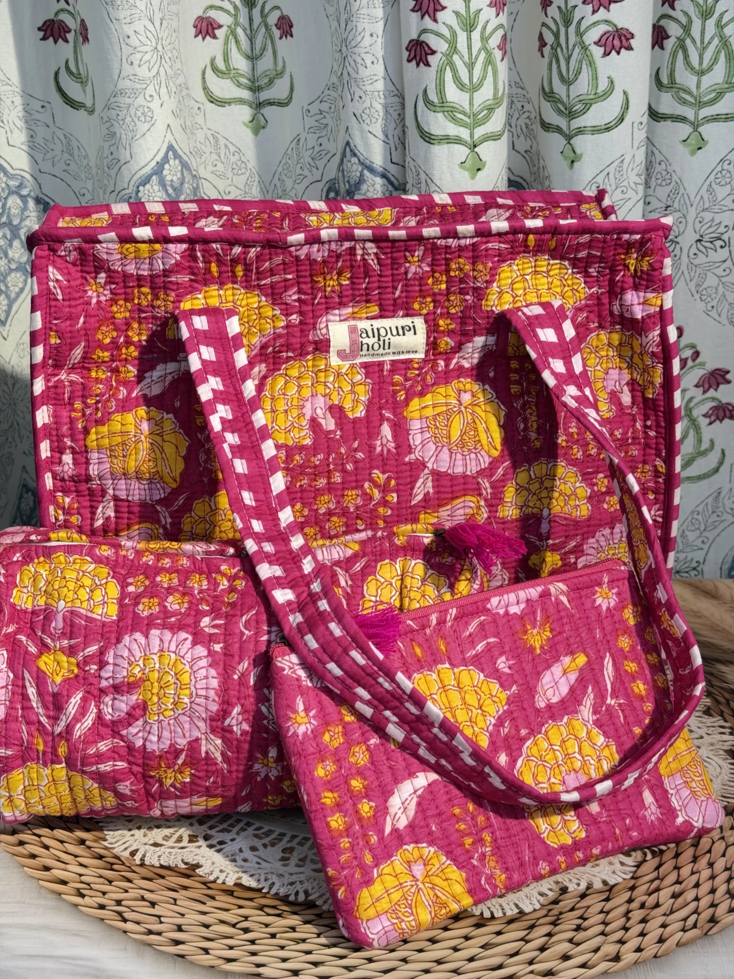 Jaipur block print medium cotton quilted zip tote bag with matching toiletry pouch and flat pouch, pink floral print, 15 × 12 × 6 inch tote, 10 × 6 inch toiletry pouch and 9 × 7 inch flat pouchfront view