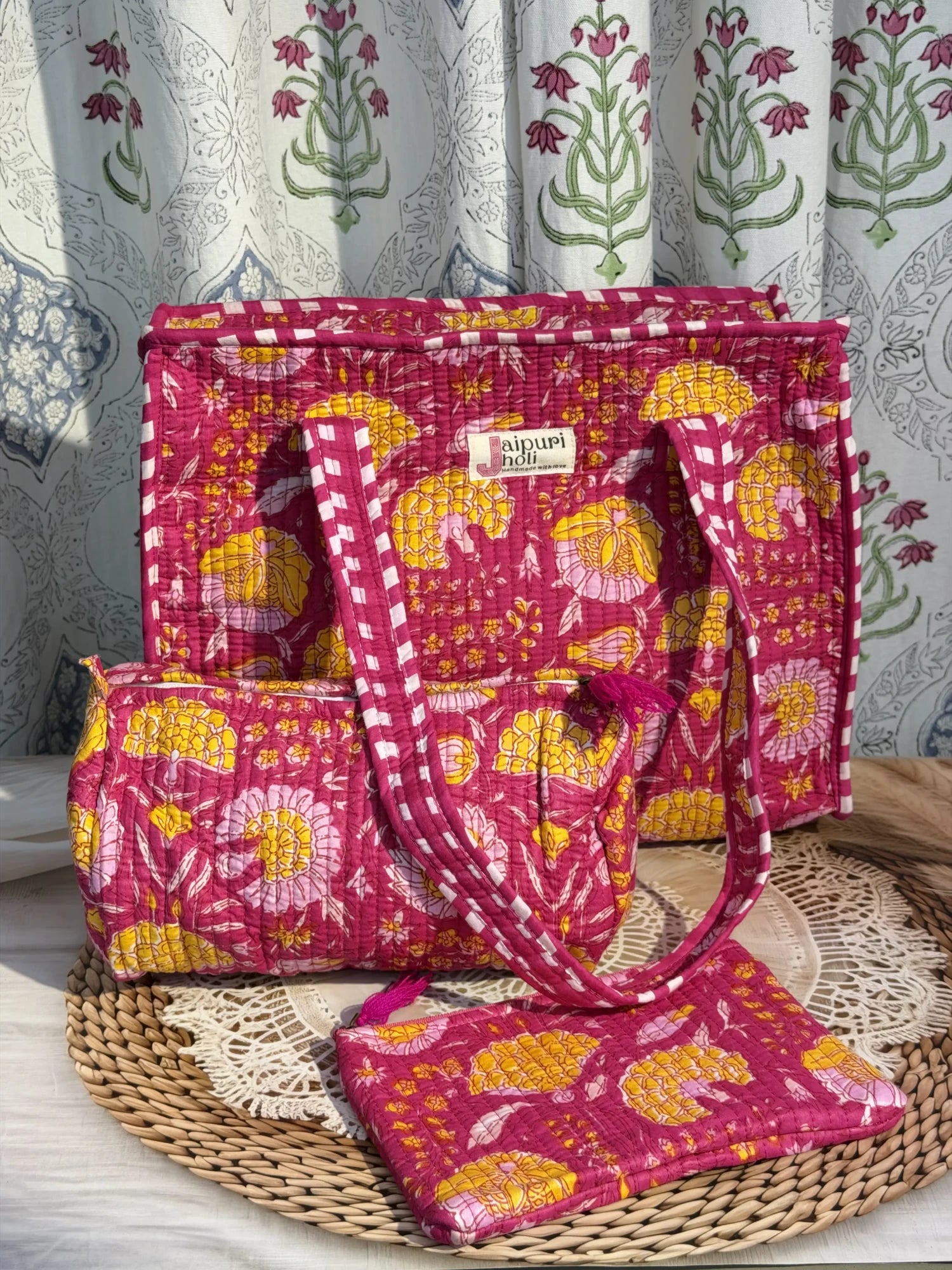 Jaipur block print medium cotton quilted zip tote bag with matching toiletry pouch and flat pouch, pink floral print, 15 × 12 × 6 inch tote, 10 × 6 inch toiletry pouch and 9 × 7 inch flat pouch side view