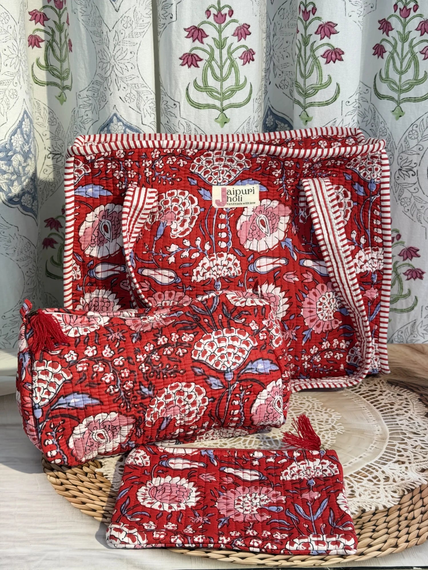 Jaipur block print medium cotton quilted zip tote bag with matching toiletry pouch and flat pouch, red floral print, 15 × 12 × 6 inch tote, 10 × 6 inch toiletry pouch and 9 × 7 inch flat pouch side view