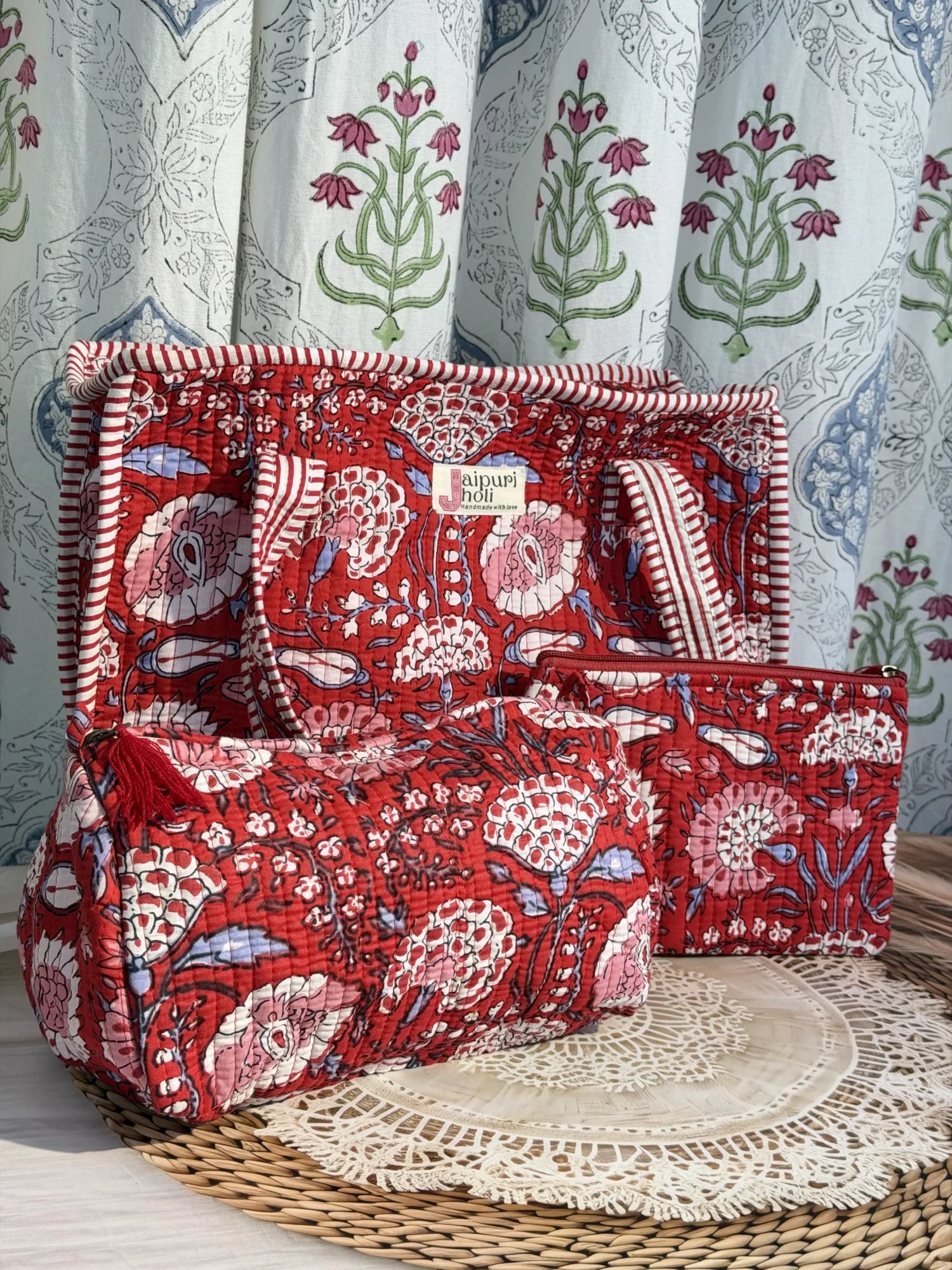 Jaipur block print medium cotton quilted zip tote bag with matching toiletry pouch and flat pouch, red floral print, 15 × 12 × 6 inch tote, 10 × 6 inch toiletry pouch and 9 × 7 inch flat pouch close-up view