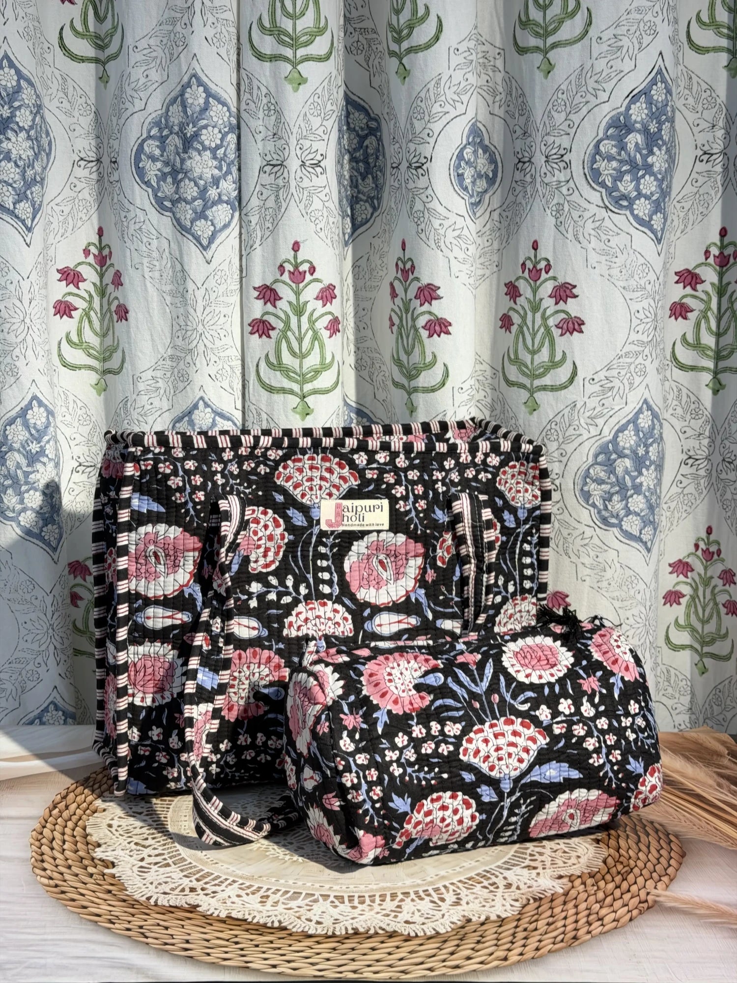 Jaipur block print cotton quilted zip tote bag with matching pouch, black and pink floral print, 15x12x6 inch tote with 10x6 inch pouch for storing cosmetics, toiletries and daily essentials front view