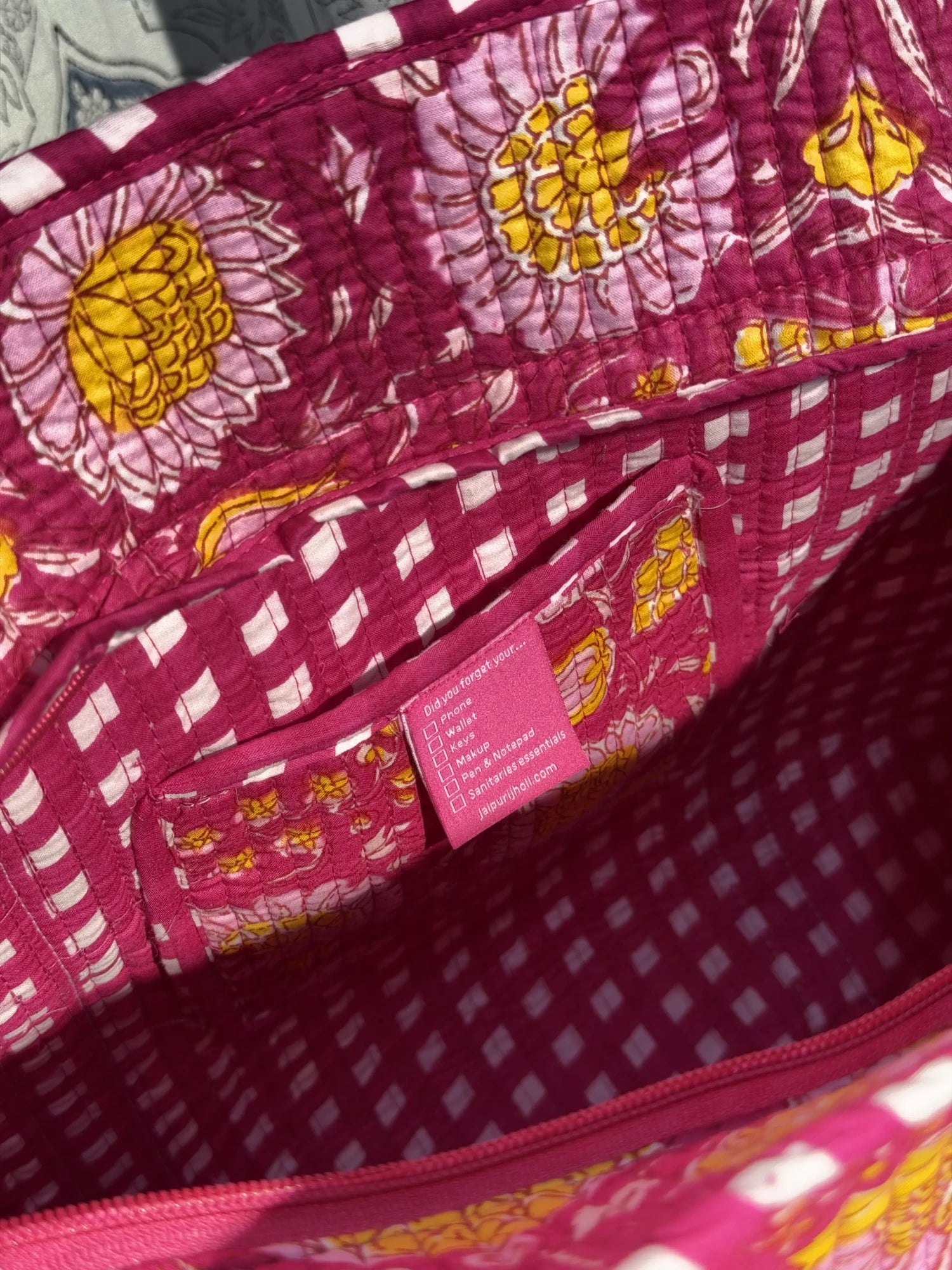 Jaipur block print cotton quilted zip tote bag with matching pouch, pink floral print, 15x12x6 inch tote with 10x6 inch pouch for organizing cosmetics, medicines and toiletries close-up view